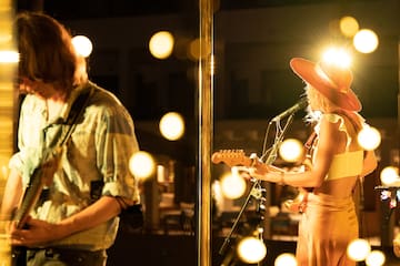 a woman playing guitar and a man playing a guitar