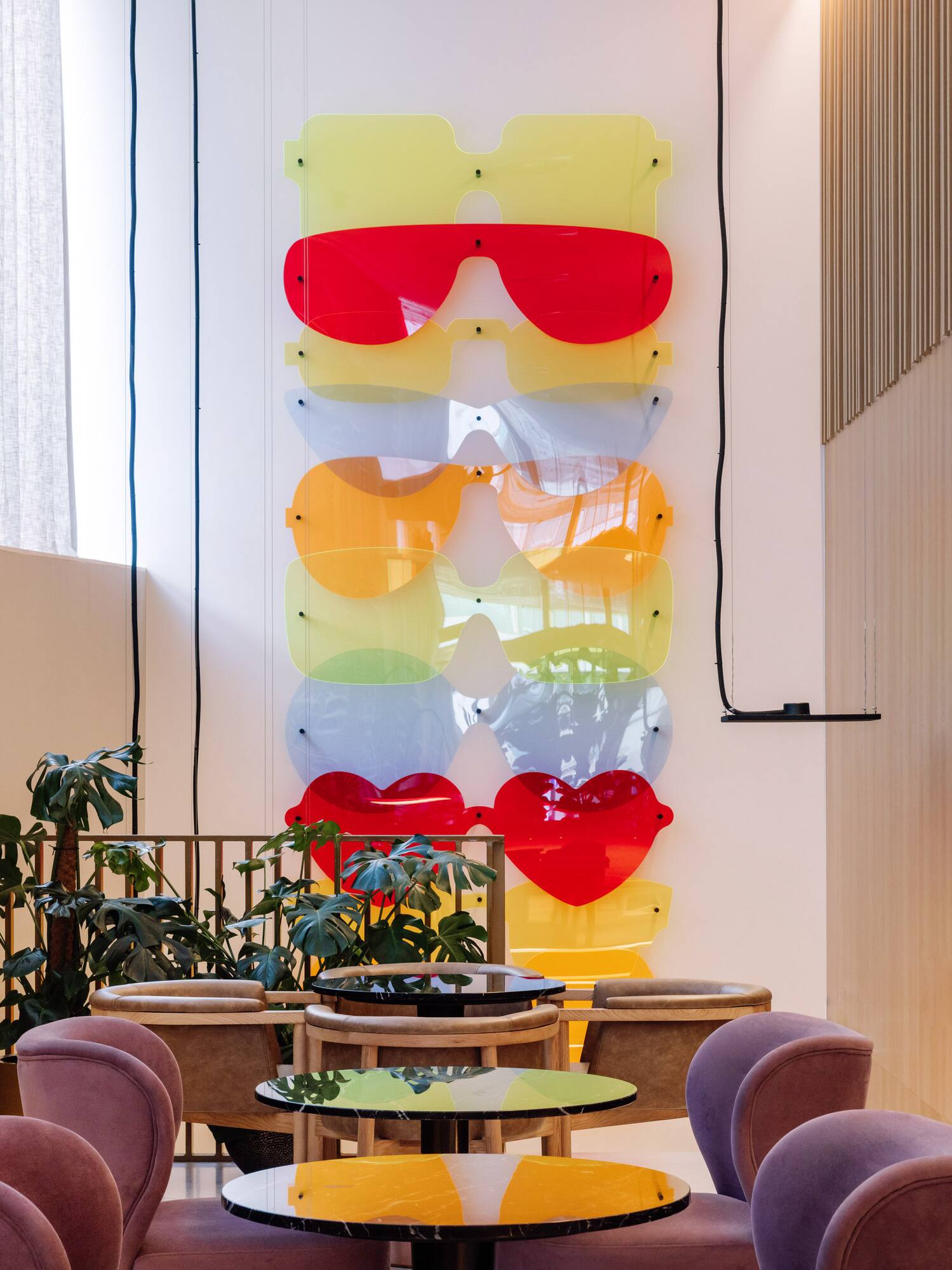 a room with chairs and tables and glasses