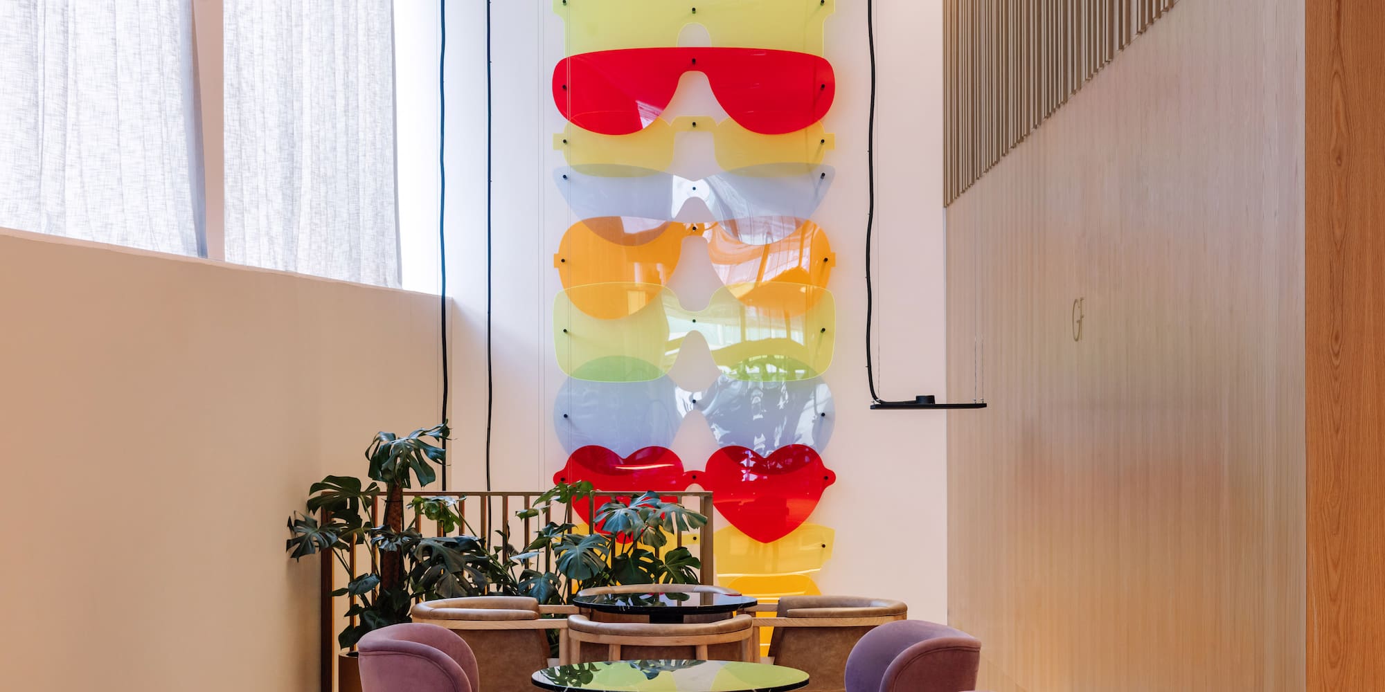 a room with chairs and tables and glasses