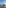 Waterfront urban scene with buildings, industrial crane, and river reflections.