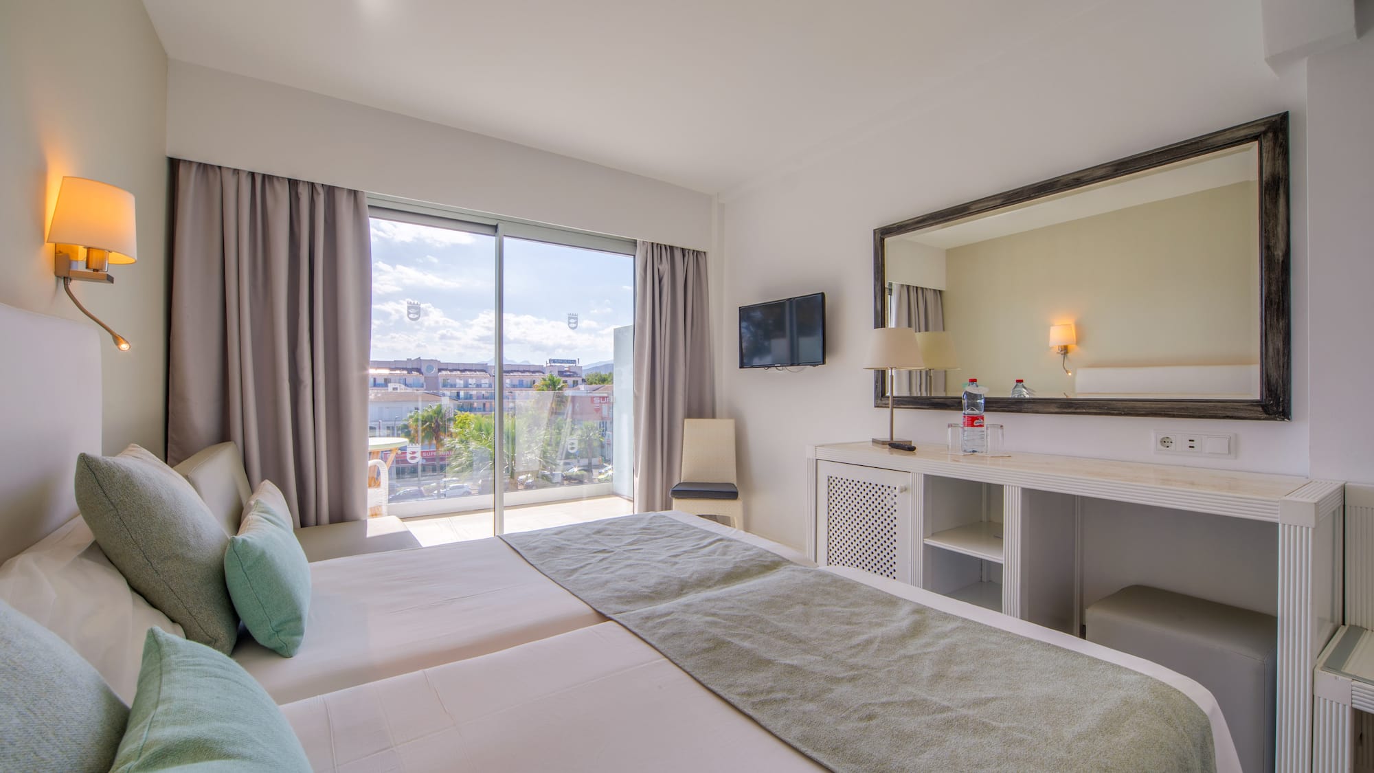 a bedroom with a large mirror and a large bed