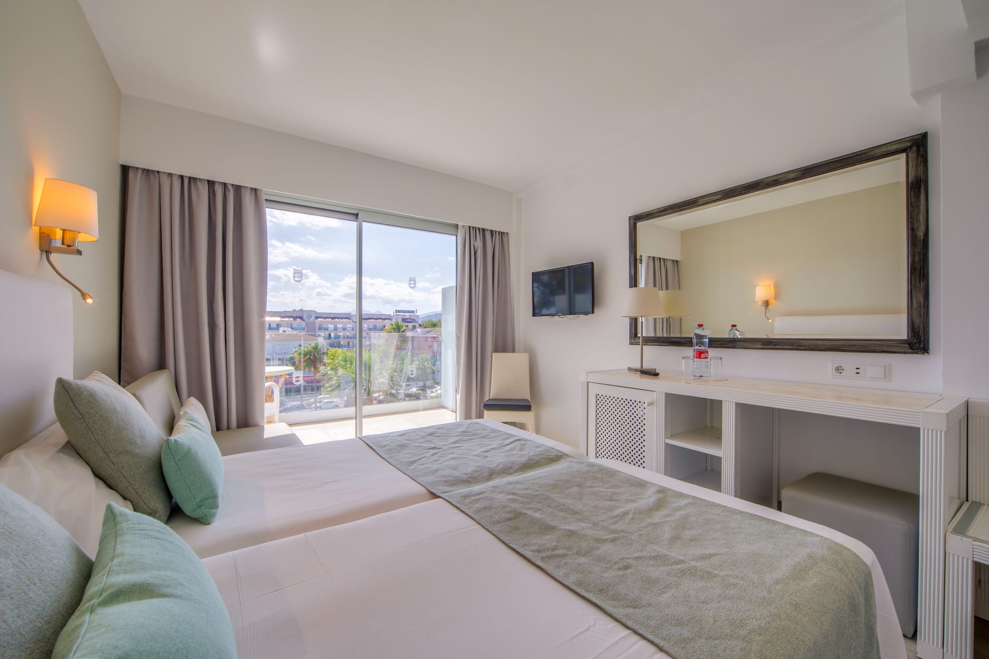 a bedroom with a large mirror and a large bed