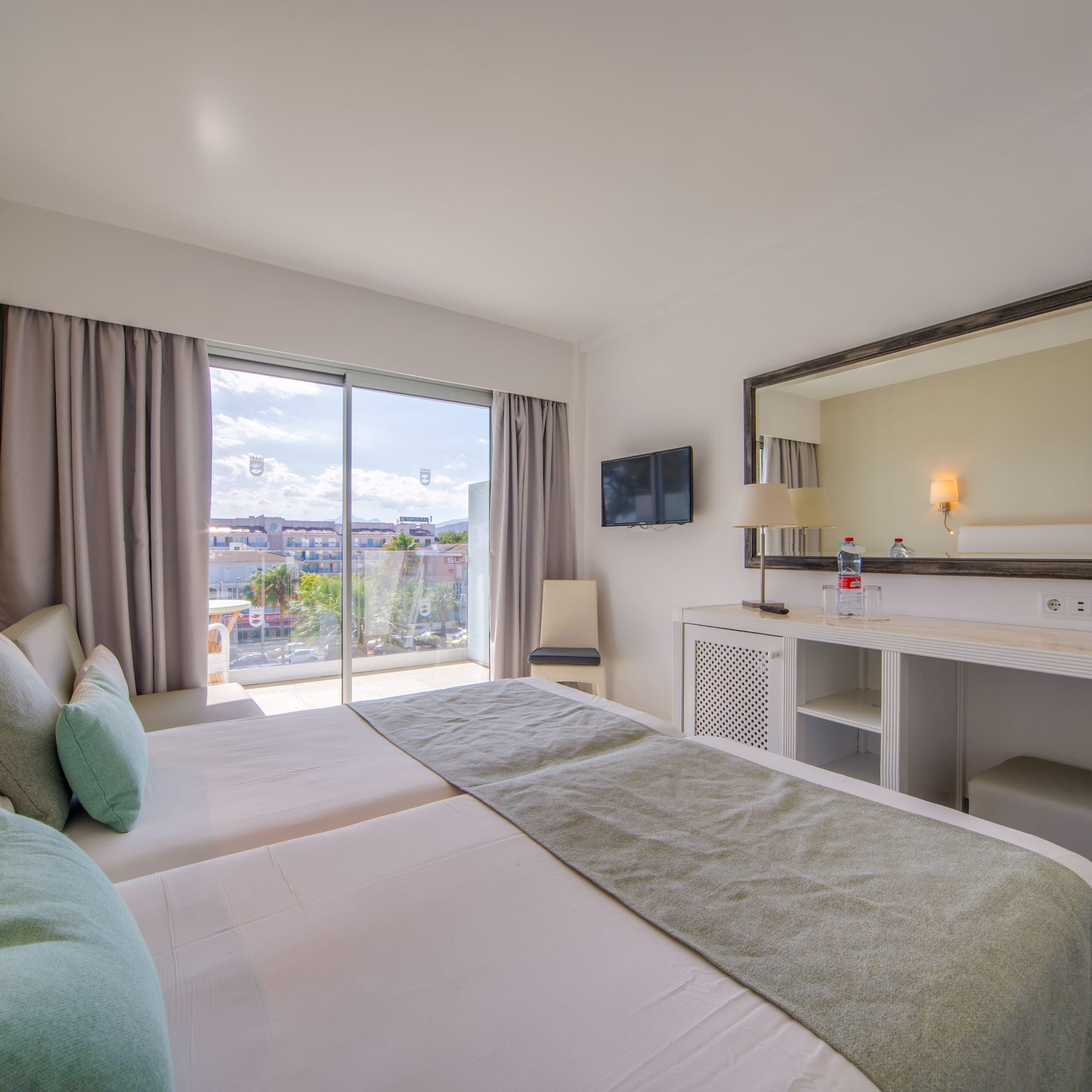 a bedroom with a large mirror and a large bed