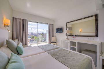 a bedroom with a large mirror and a large bed