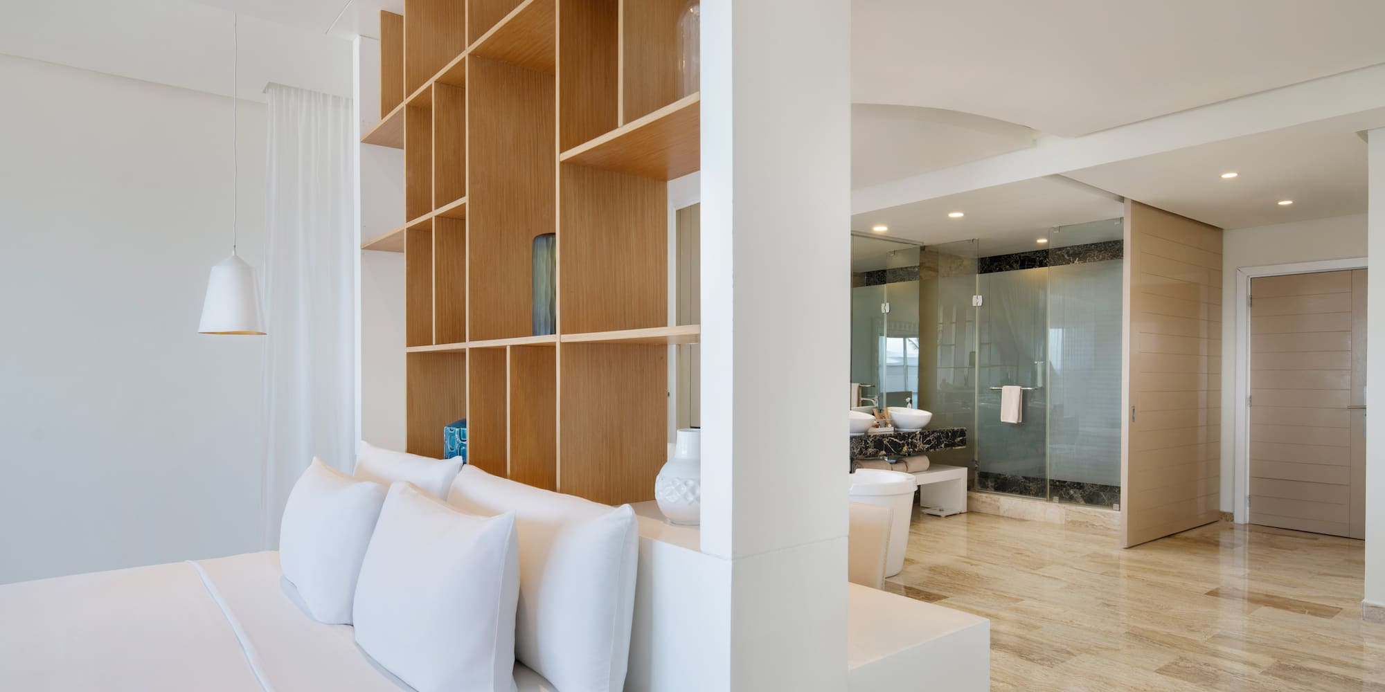 a room with a bed and shelves