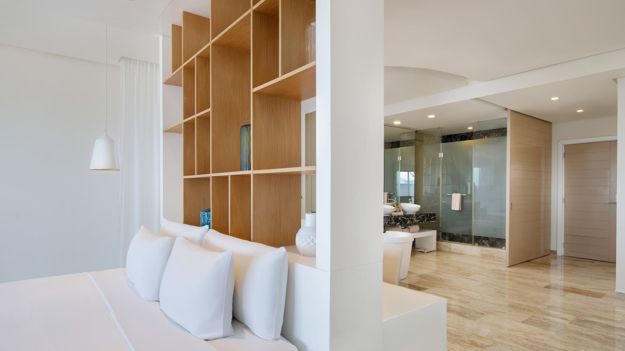 a room with a bed and shelves