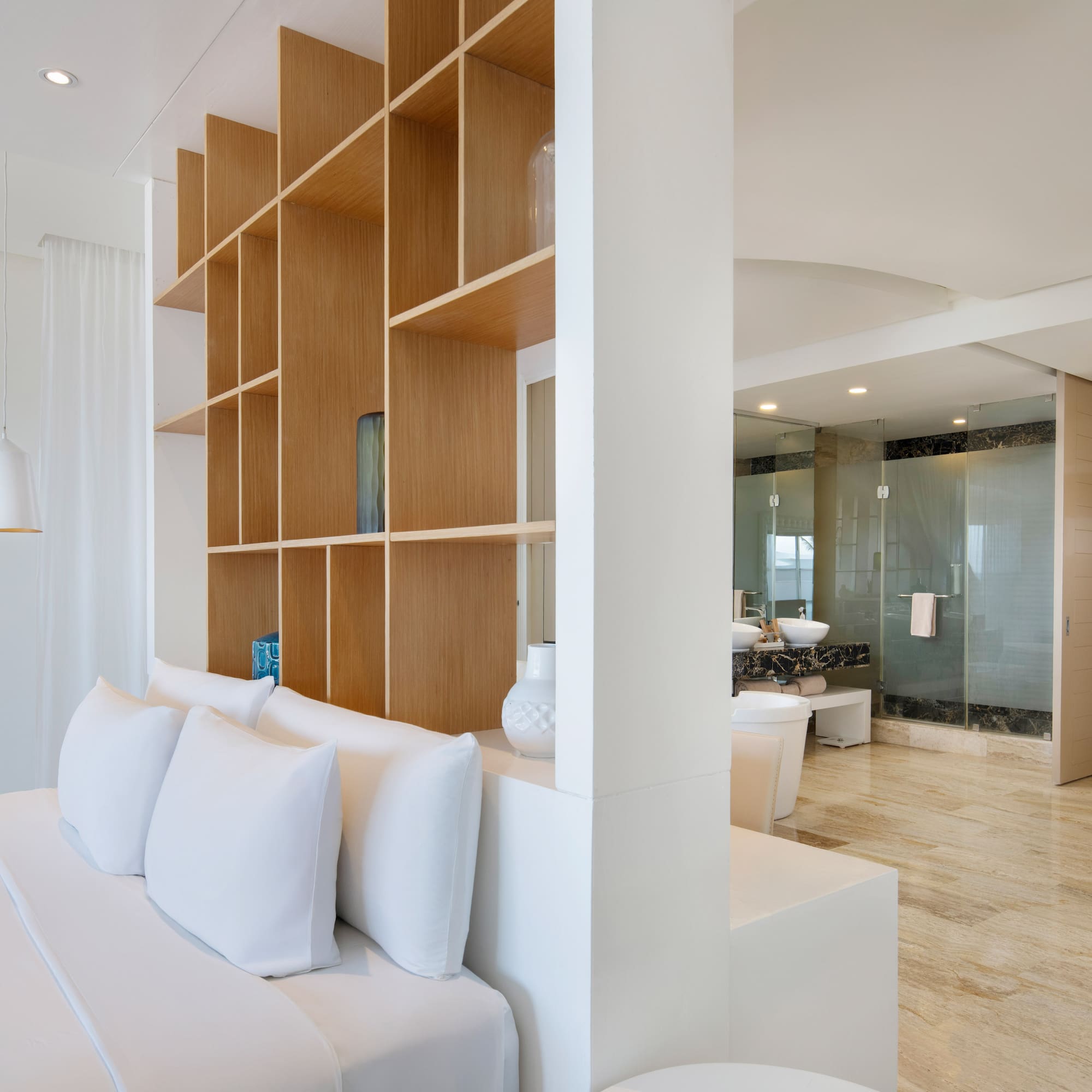 a room with a bed and shelves