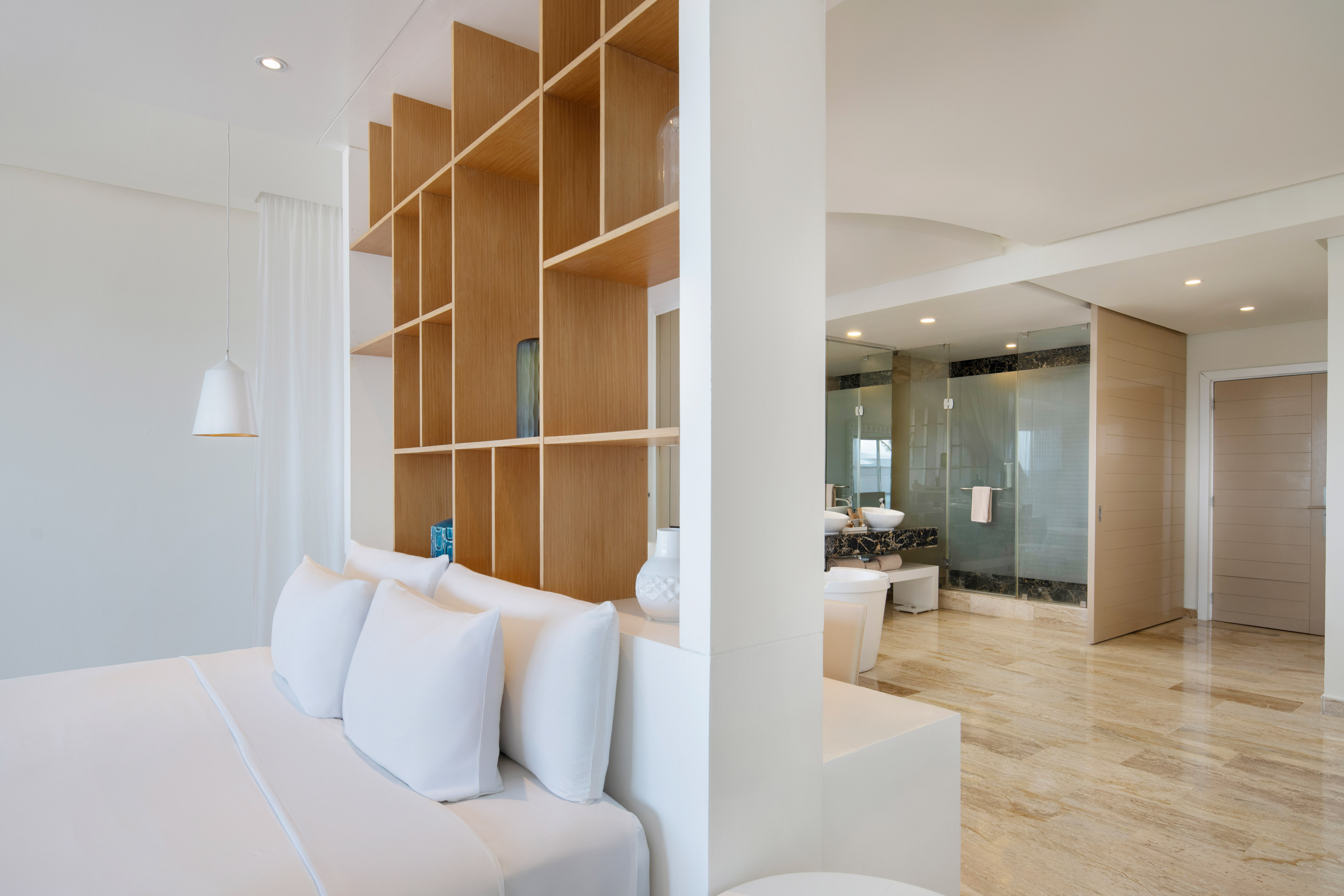 a room with a bed and shelves