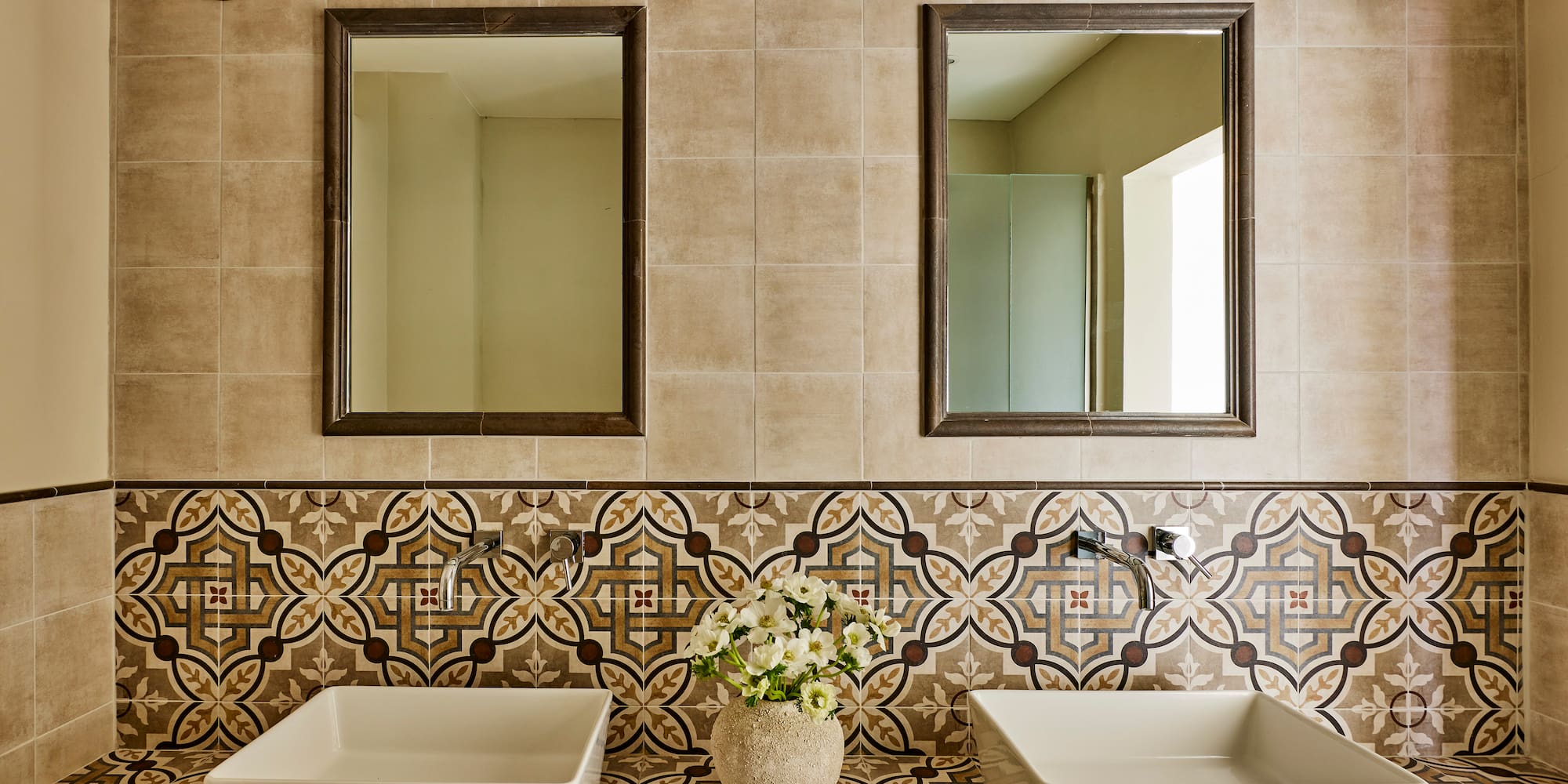 a bathroom with sinks and mirrors