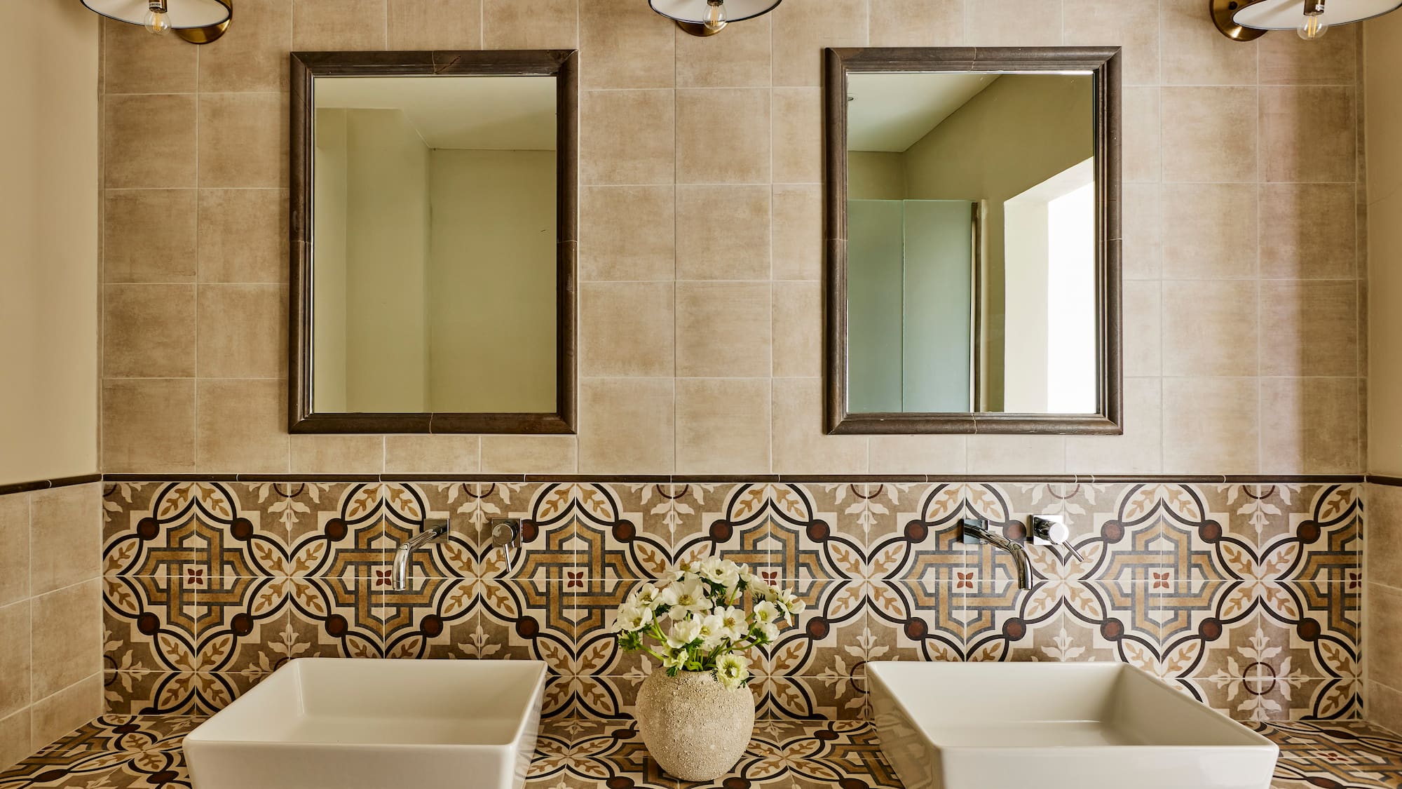 a bathroom with sinks and mirrors