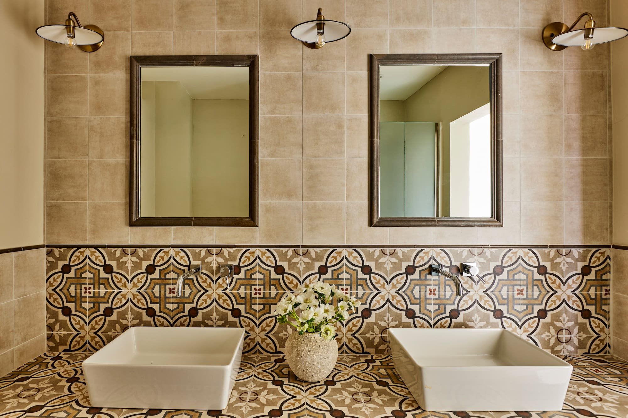 a bathroom with sinks and mirrors