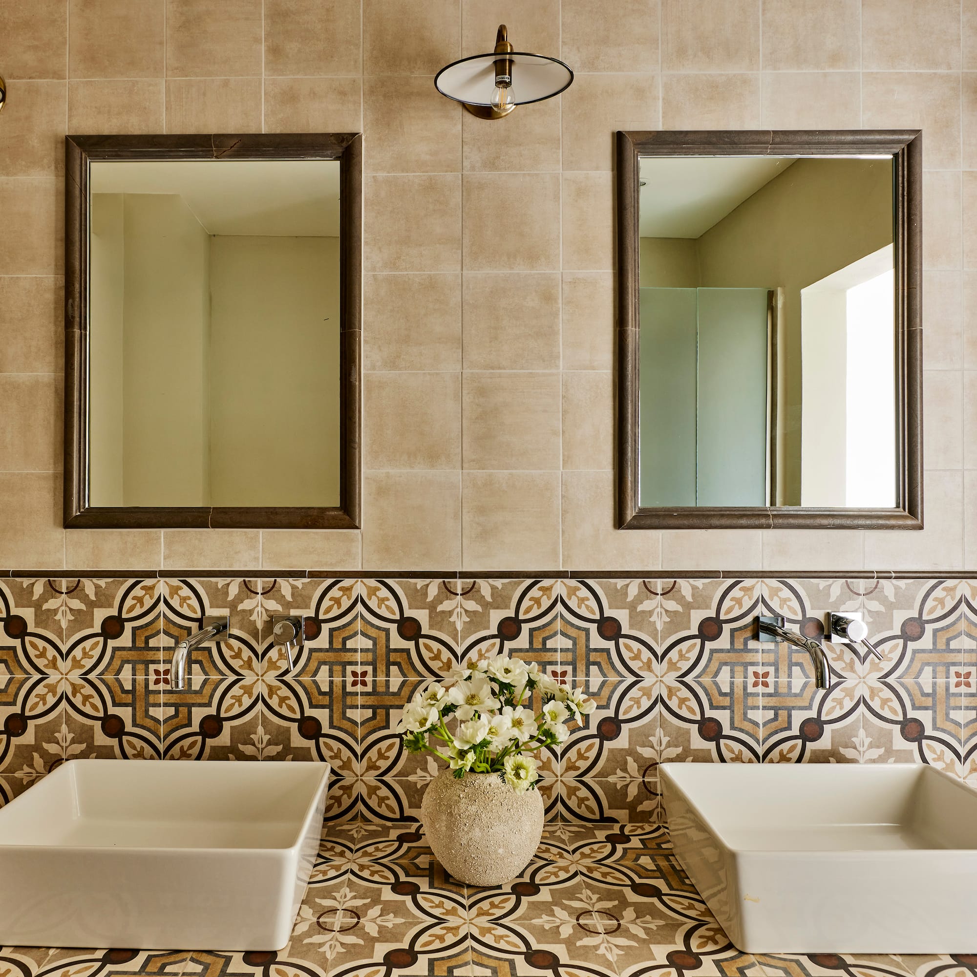 a bathroom with sinks and mirrors