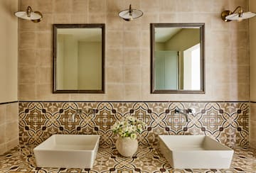 a bathroom with sinks and mirrors