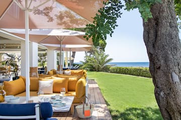 a patio with a table and chairs and umbrellas