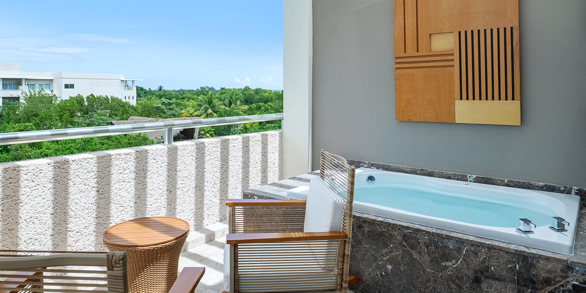 a patio with a hot tub and chairs