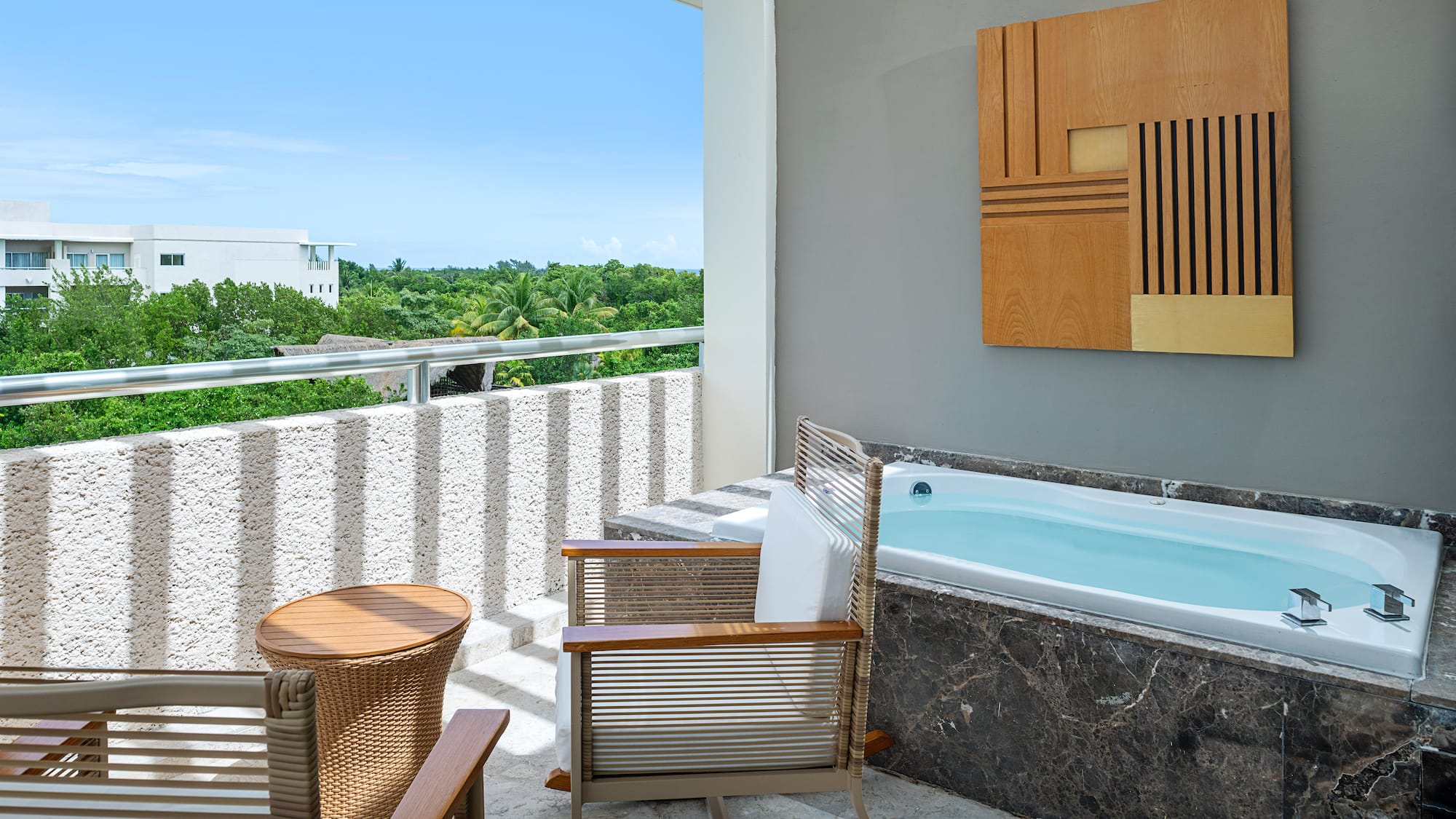 a patio with a hot tub and chairs