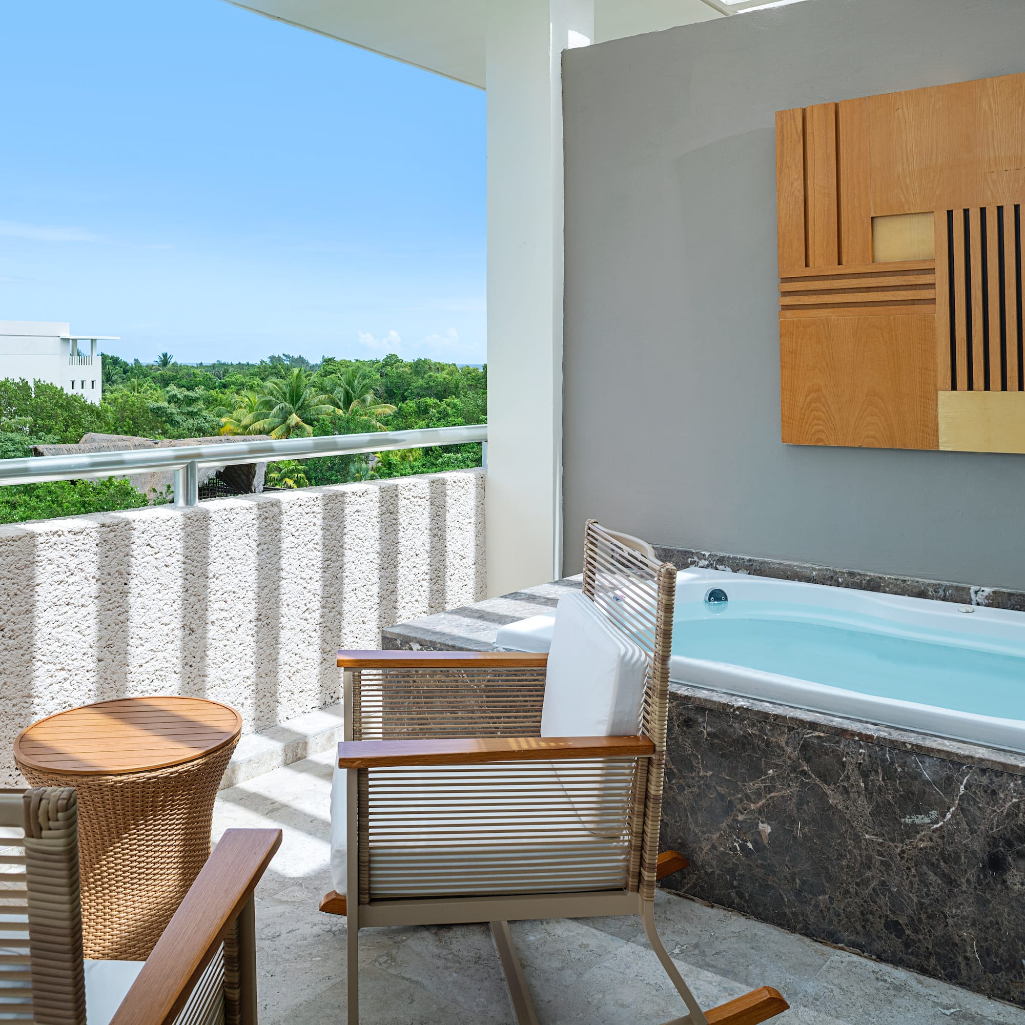 a patio with a hot tub and chairs