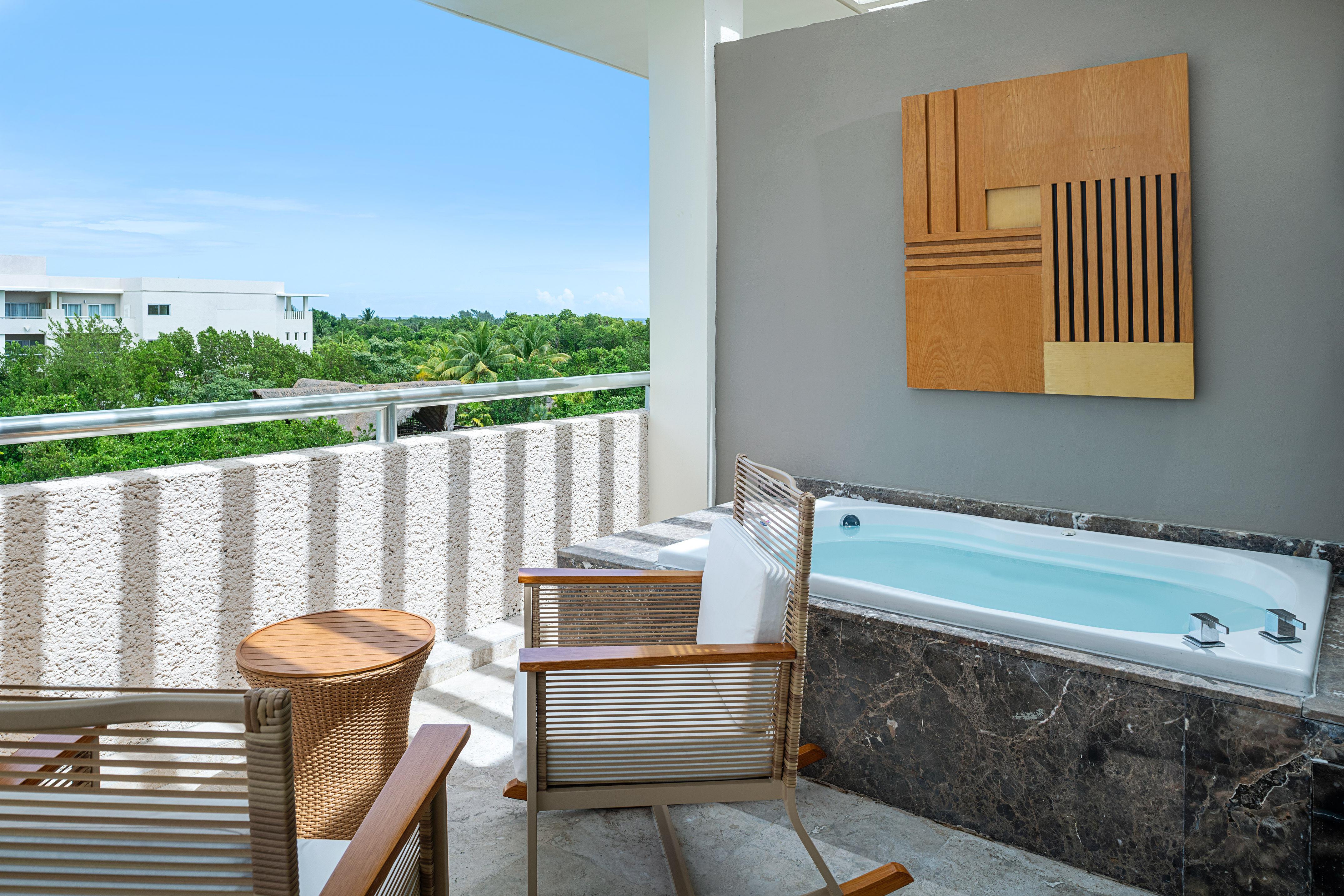 a patio with a hot tub and chairs