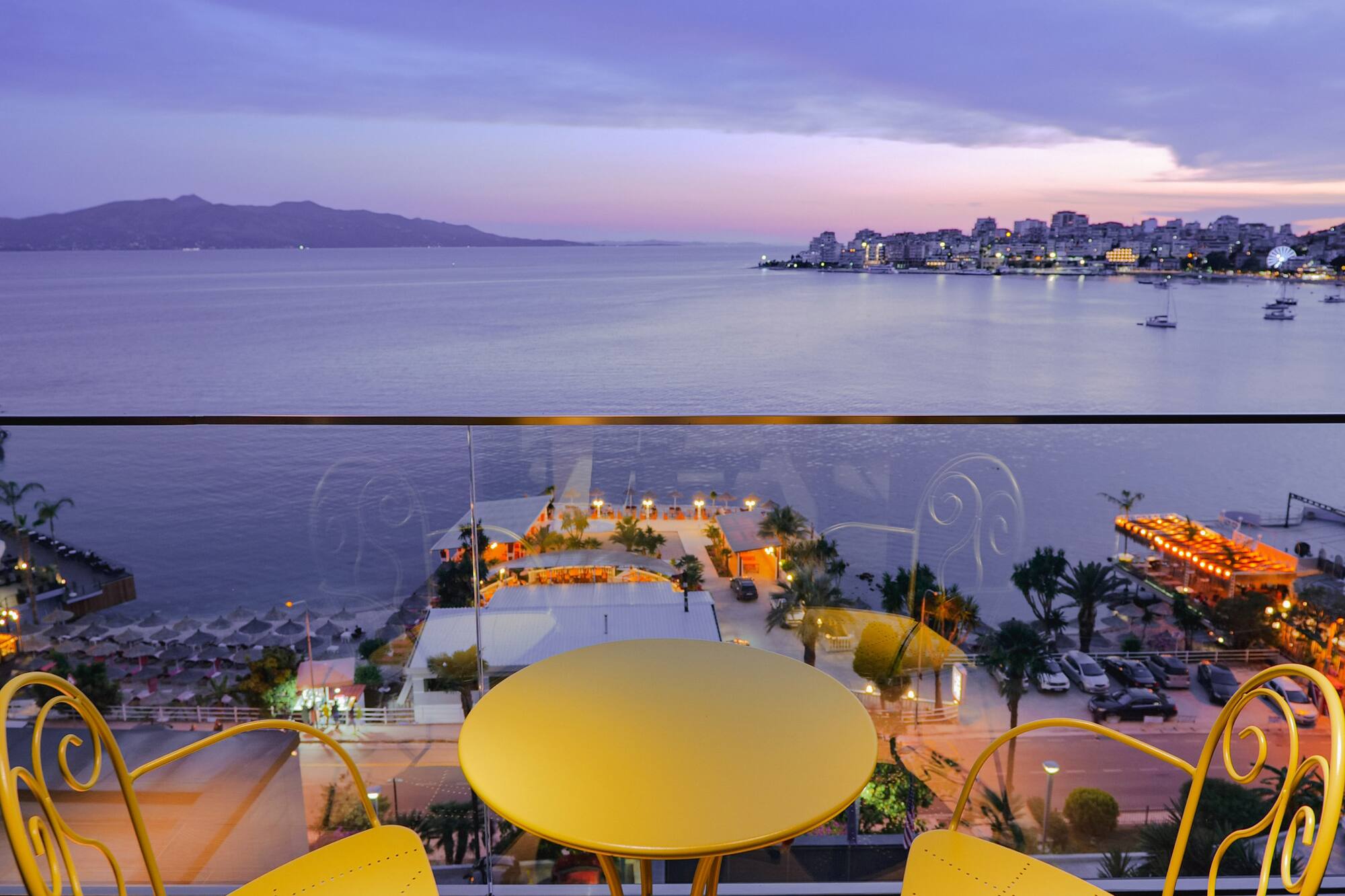 a table and chairs overlooking a body of water