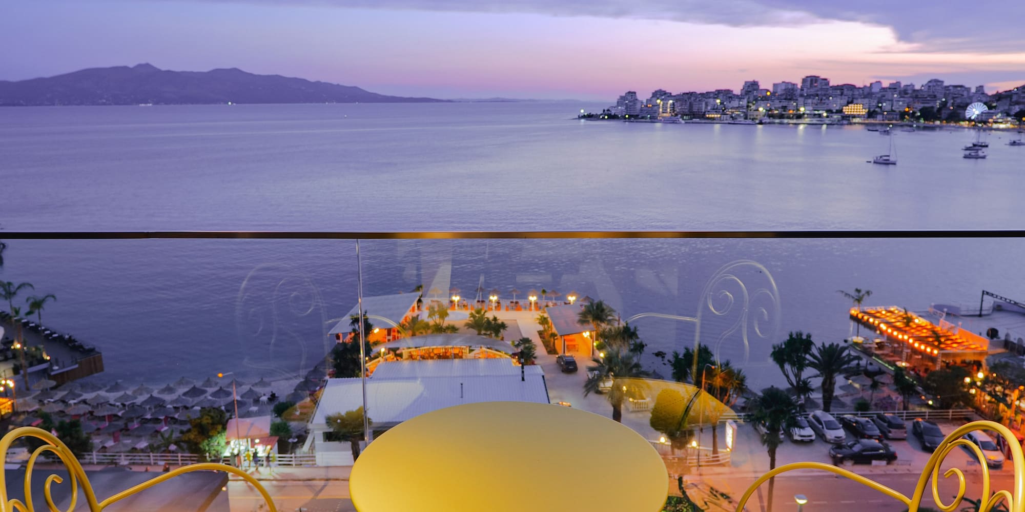 a table and chairs overlooking a body of water
