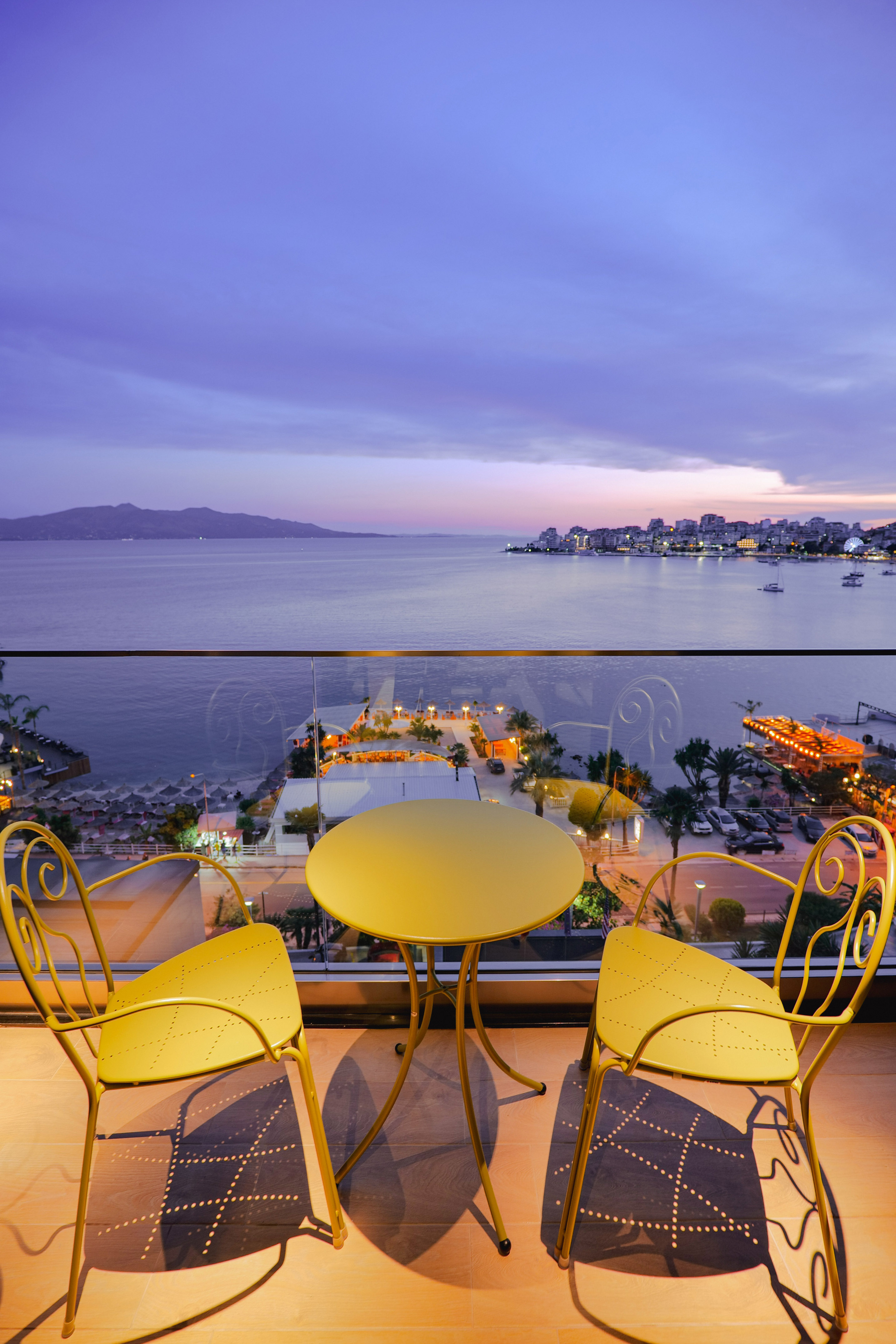 a table and chairs overlooking a body of water