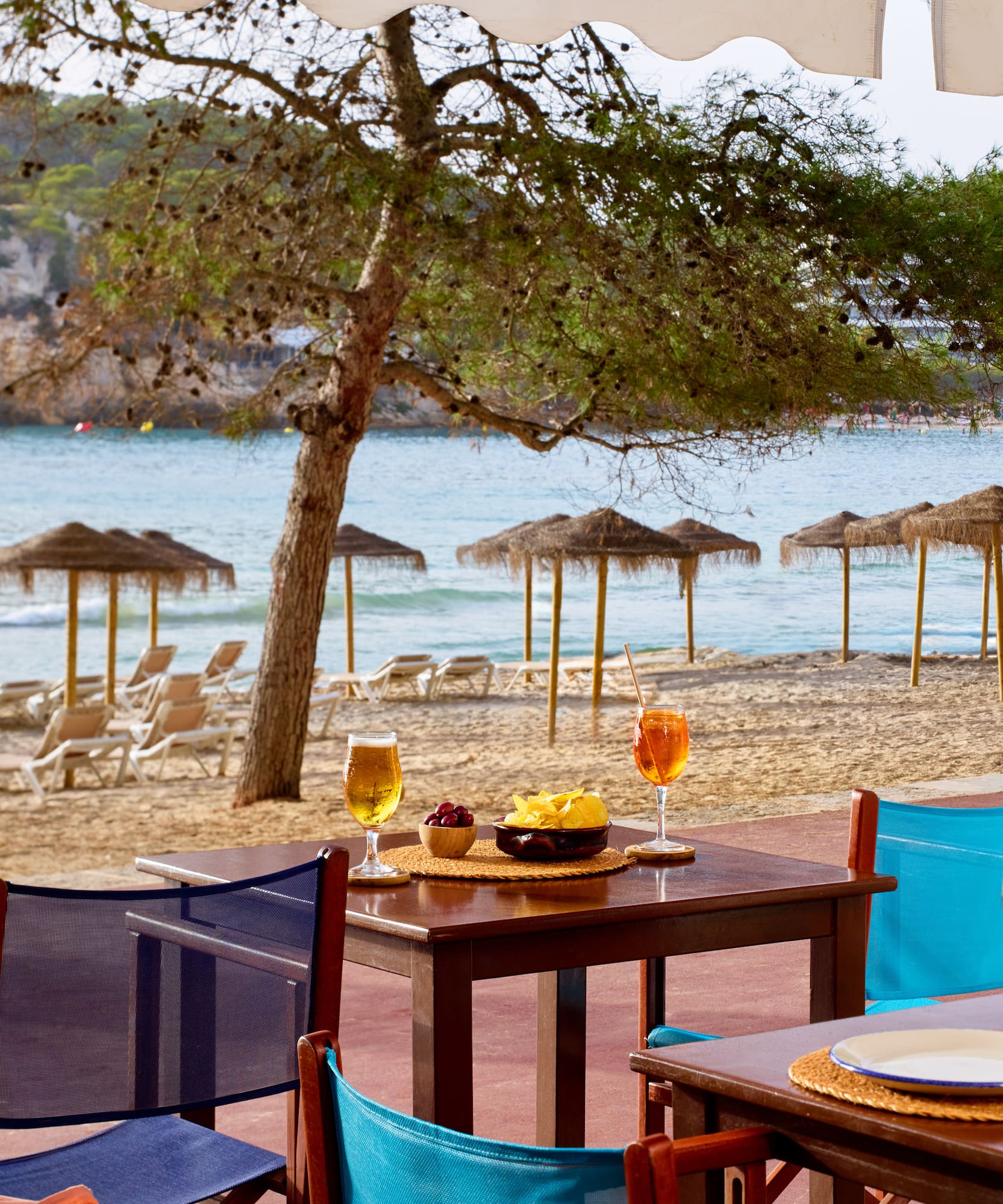 a table and chairs on a beach