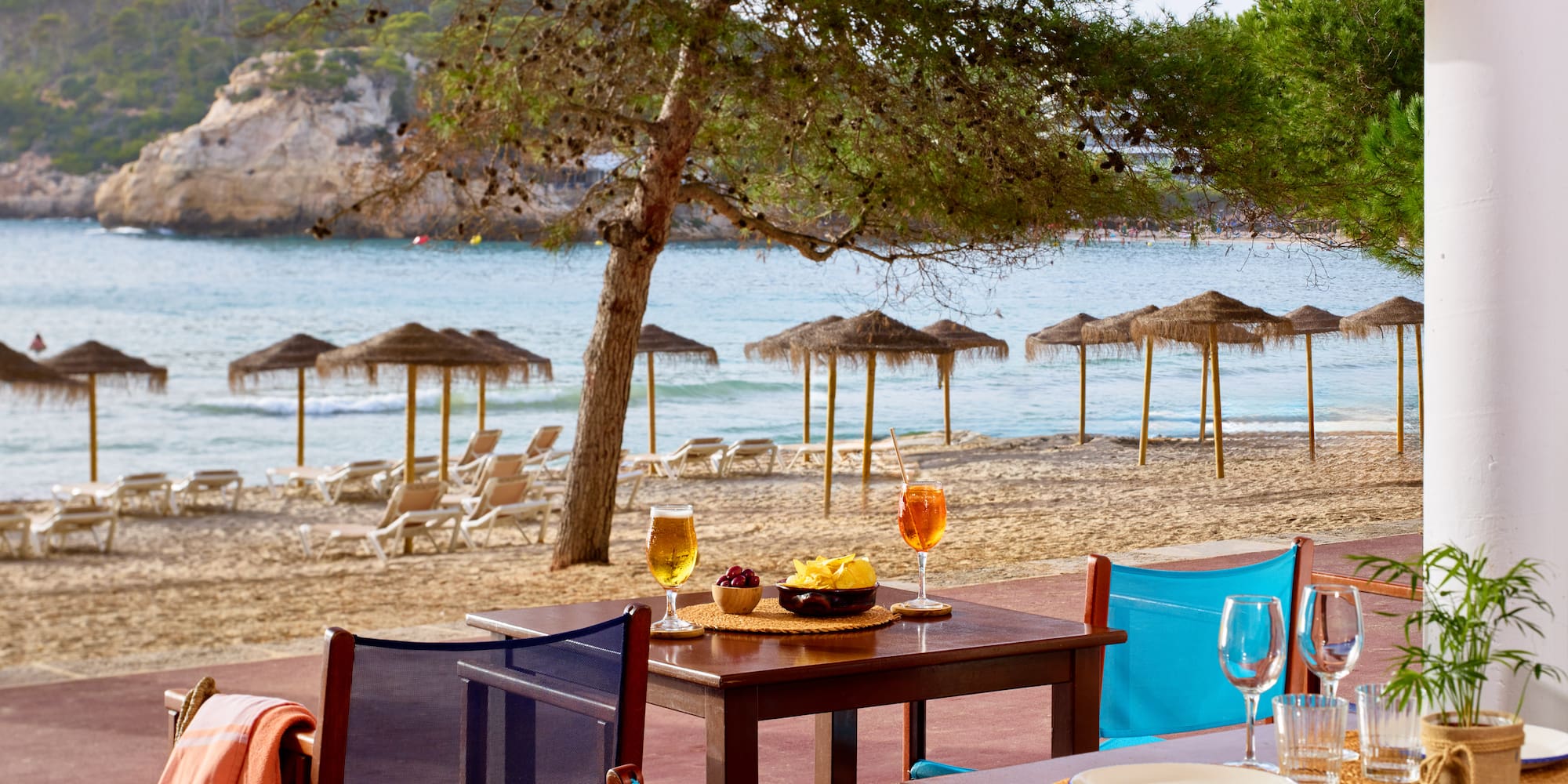 a table and chairs on a beach