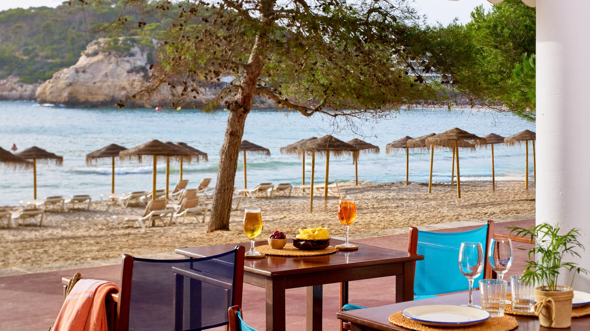 a table and chairs on a beach