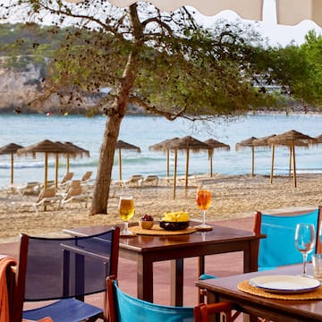 a table and chairs on a beach