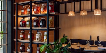 a shelf with jars of food and vegetables