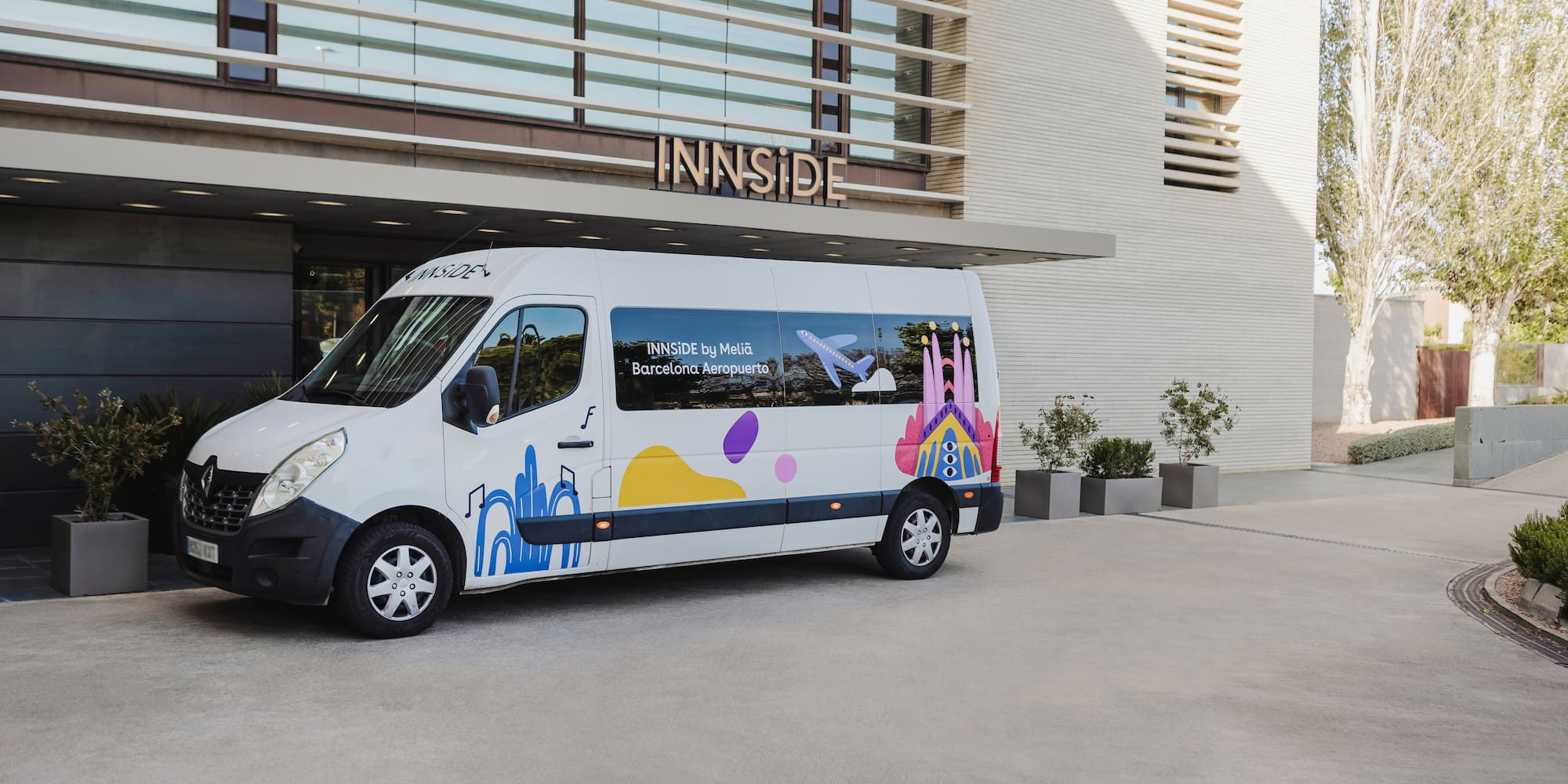 a white van with colorful designs in front of a building