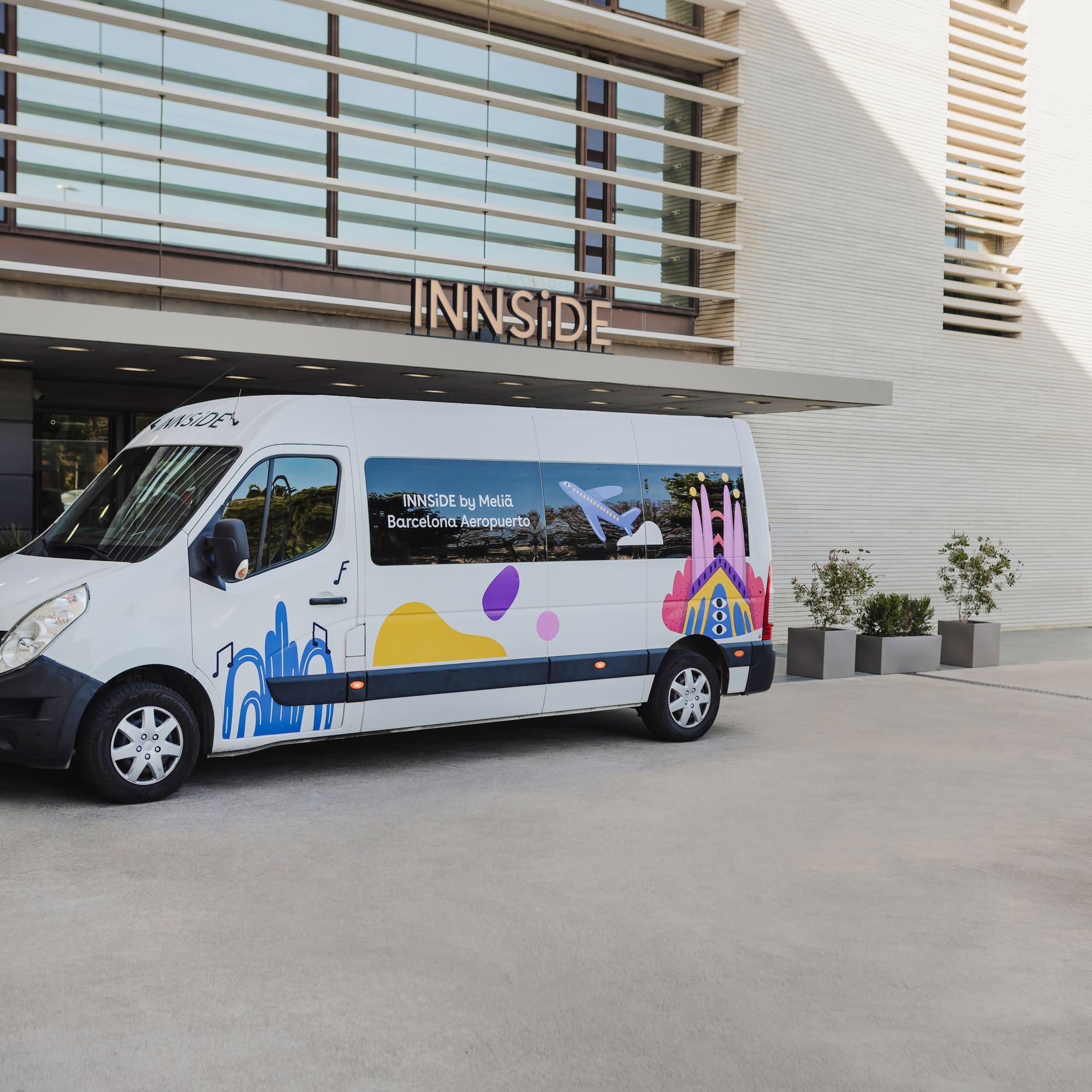 a white van with colorful designs in front of a building