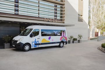 a white van with colorful designs in front of a building