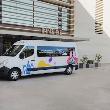 a white van with colorful designs in front of a building