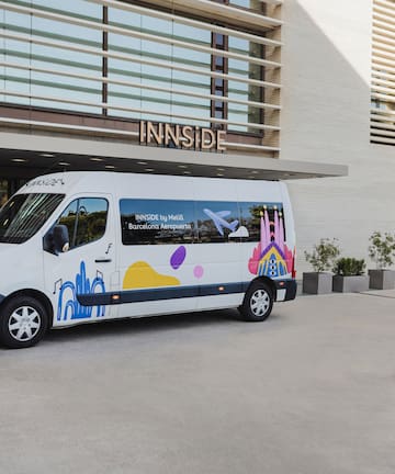 a white van with colorful designs in front of a building