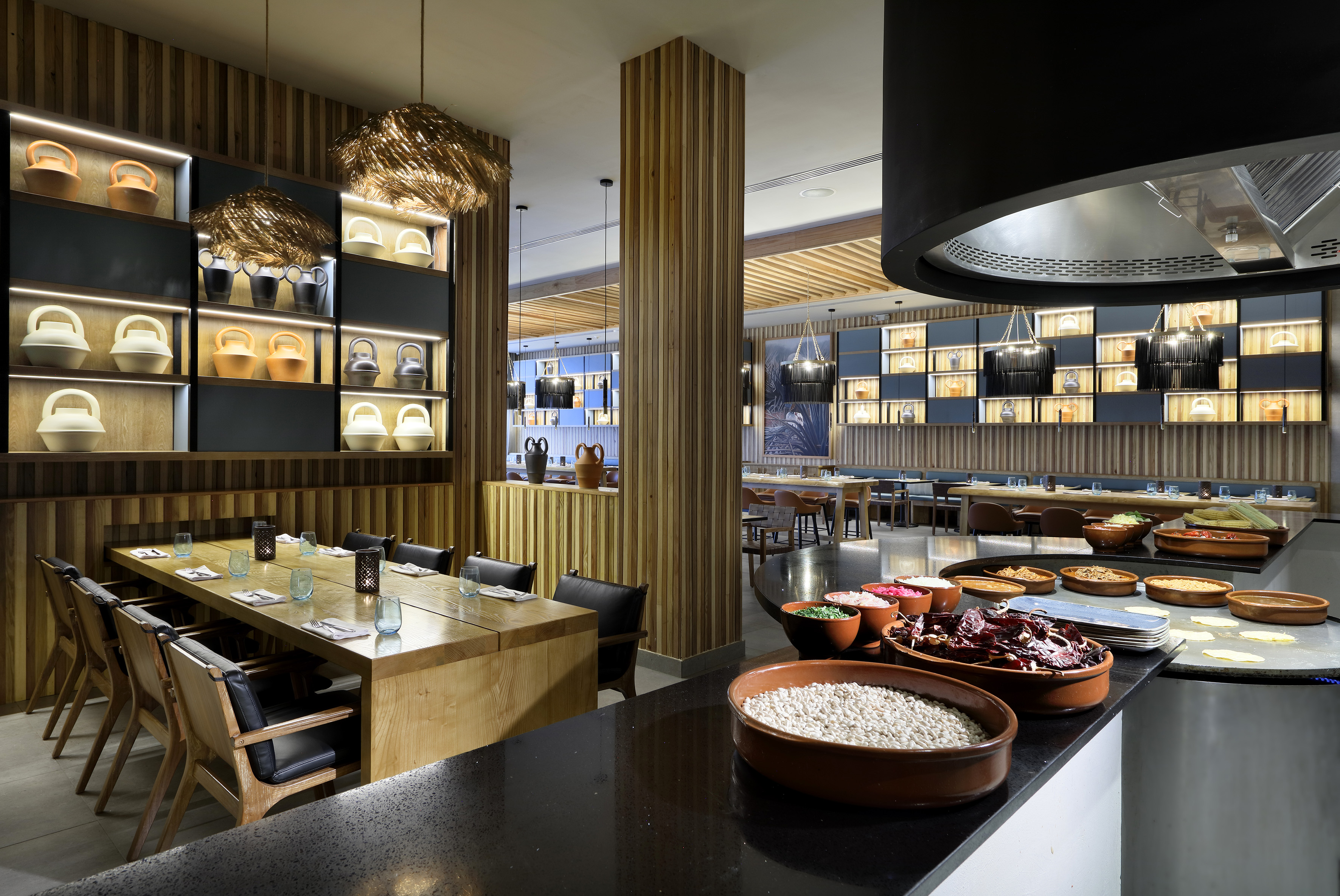 Modern restaurant interior, buffet with fresh ingredients, and elegant decor.