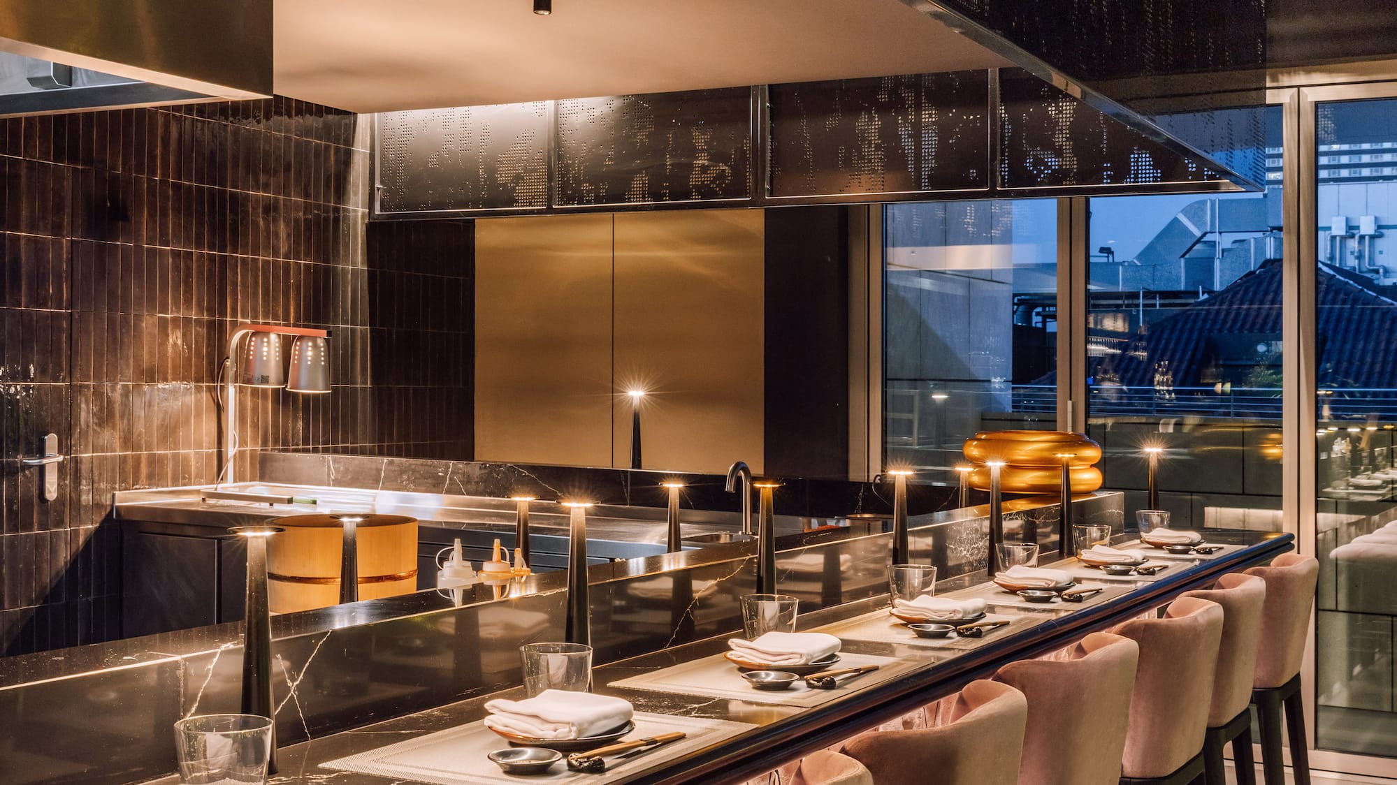 a long table with chairs and plates on it