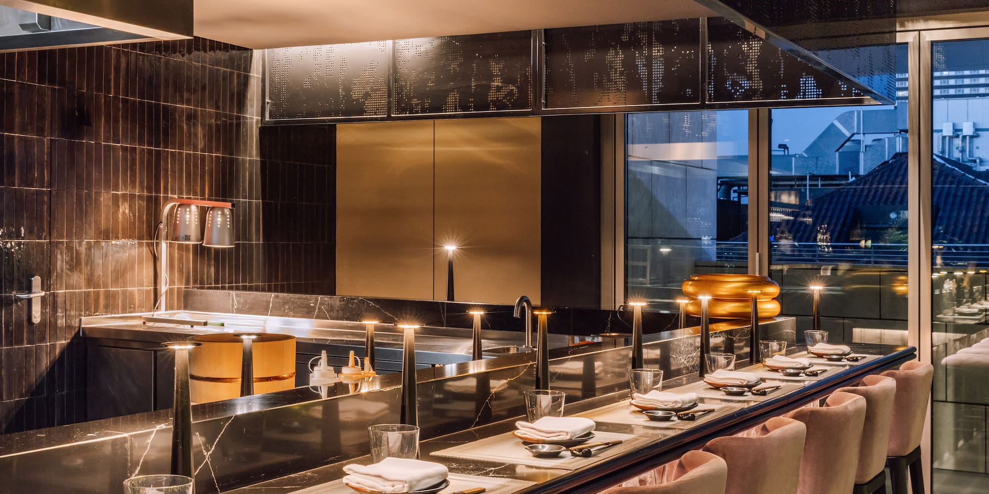 a long table with chairs and plates on it