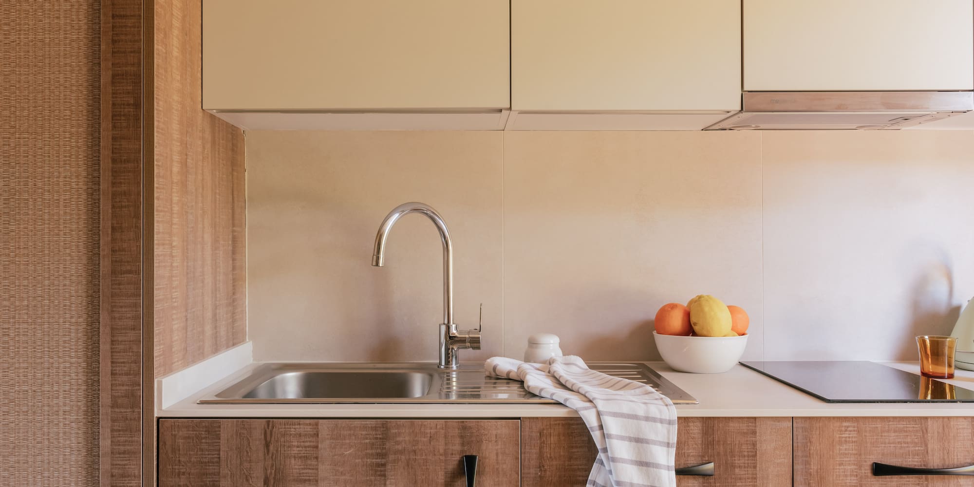a kitchen with a sink and fruit