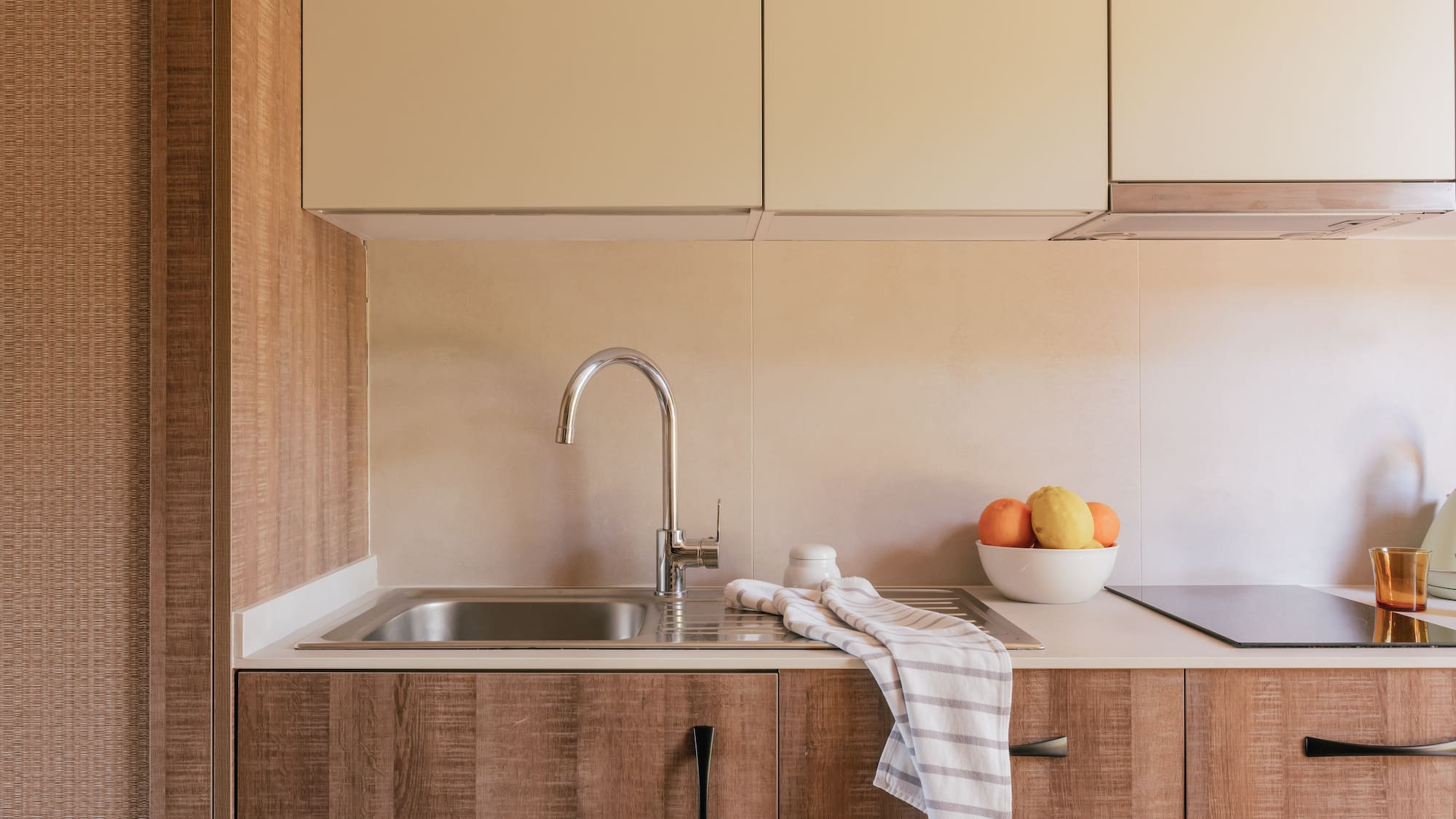a kitchen with a sink and fruit