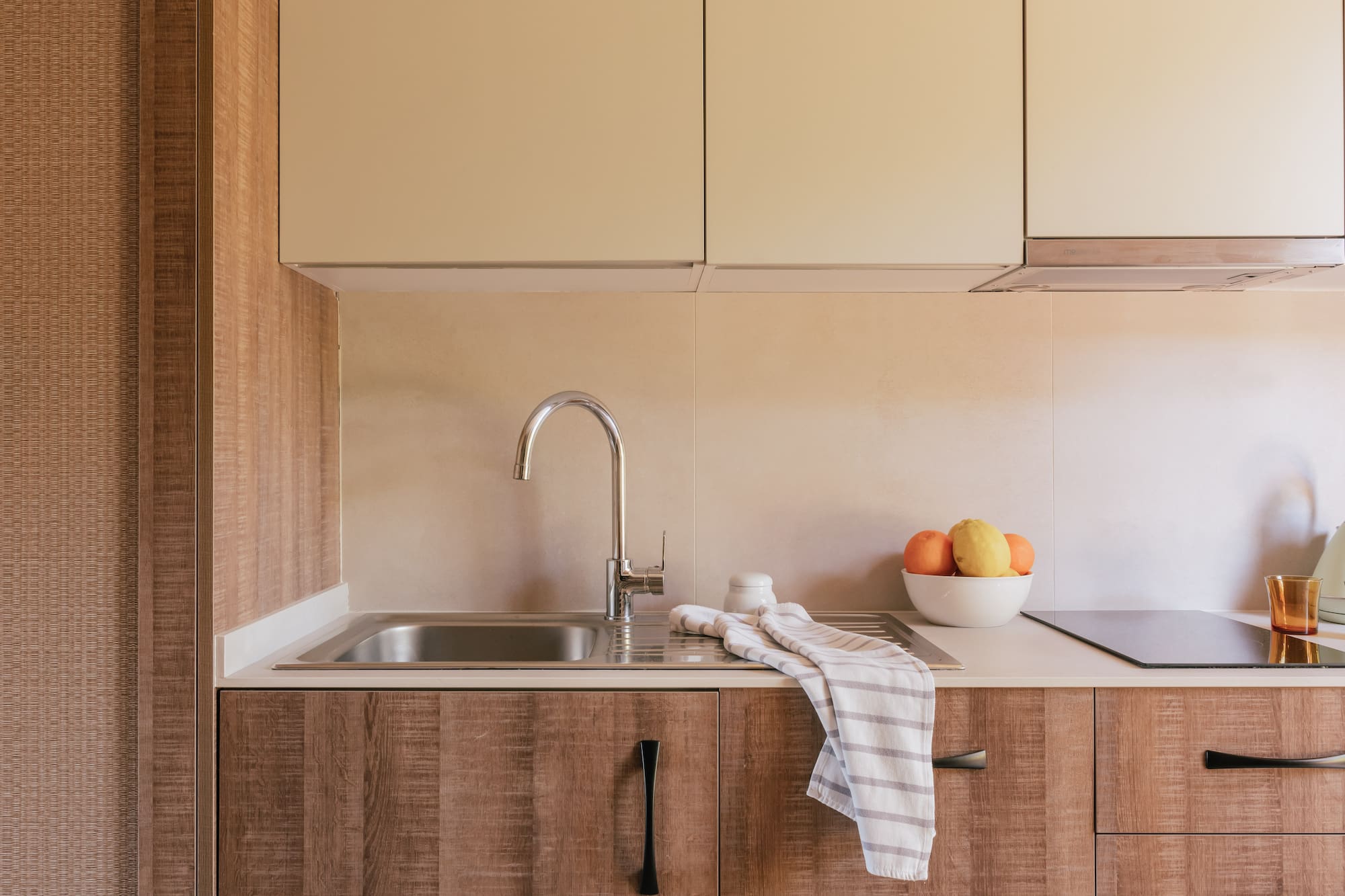 a kitchen with a sink and fruit