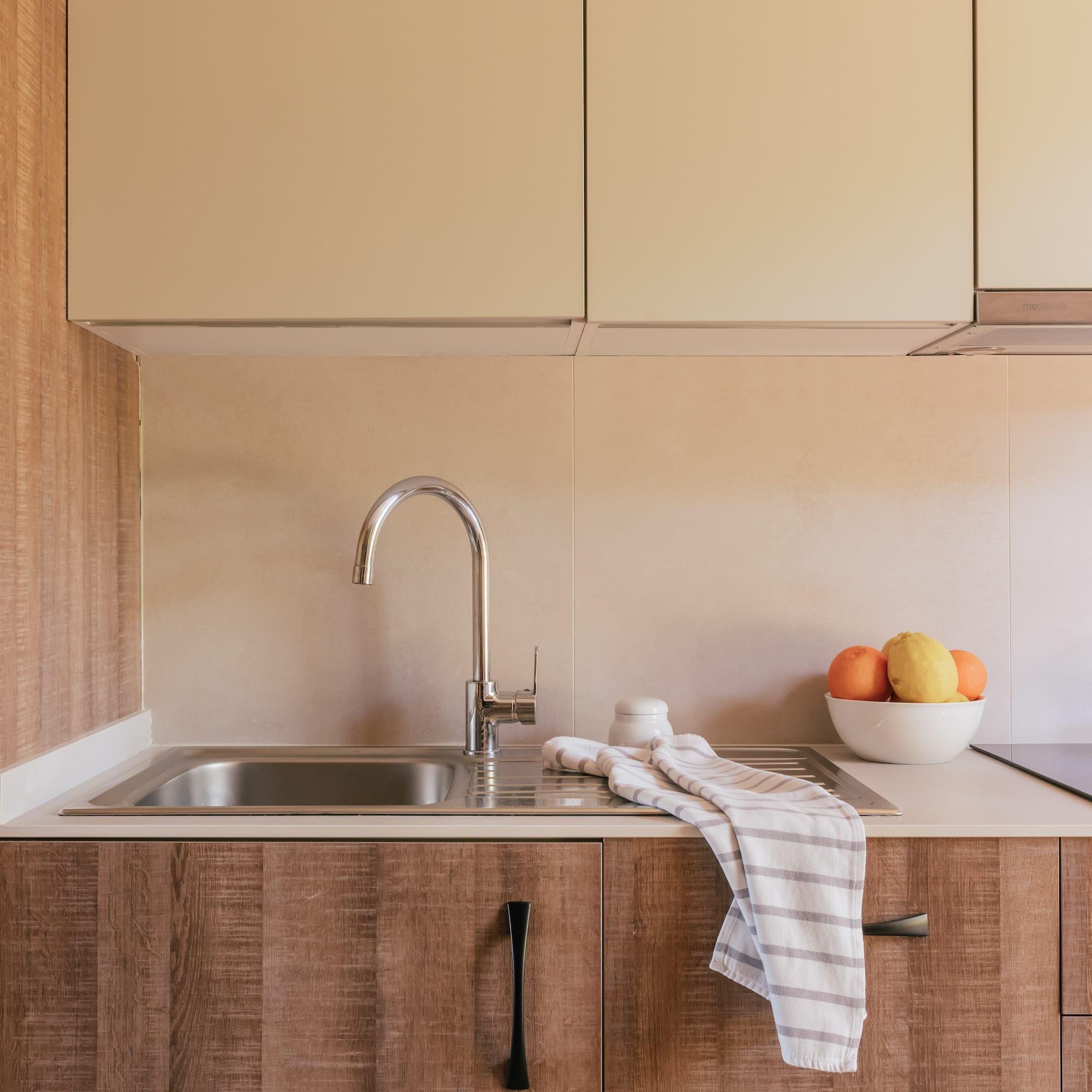 a kitchen with a sink and fruit