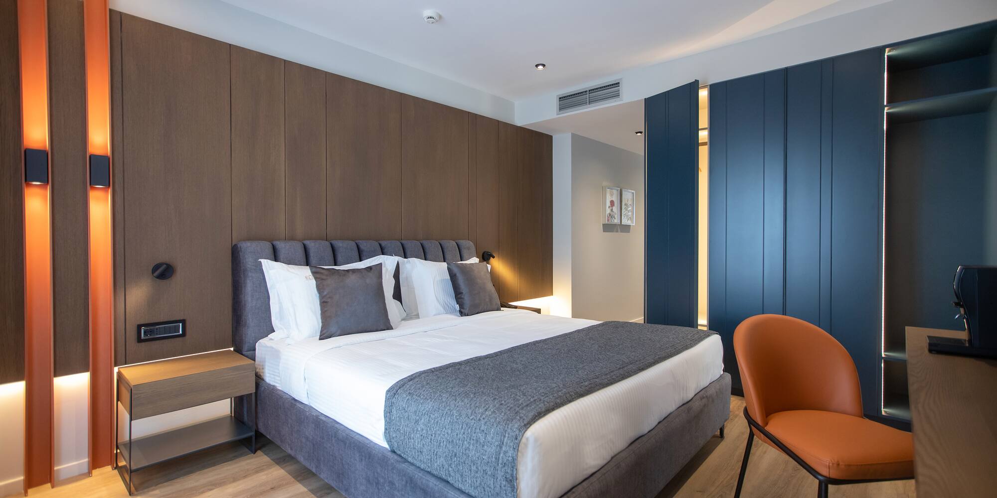 a bedroom with a bed and a chair