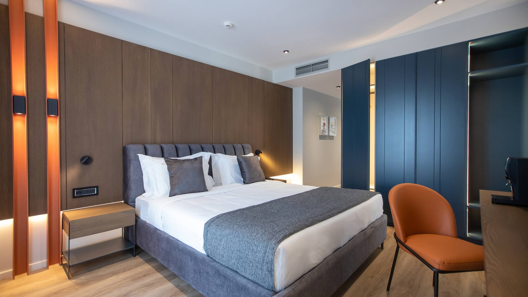 a bedroom with a bed and a chair