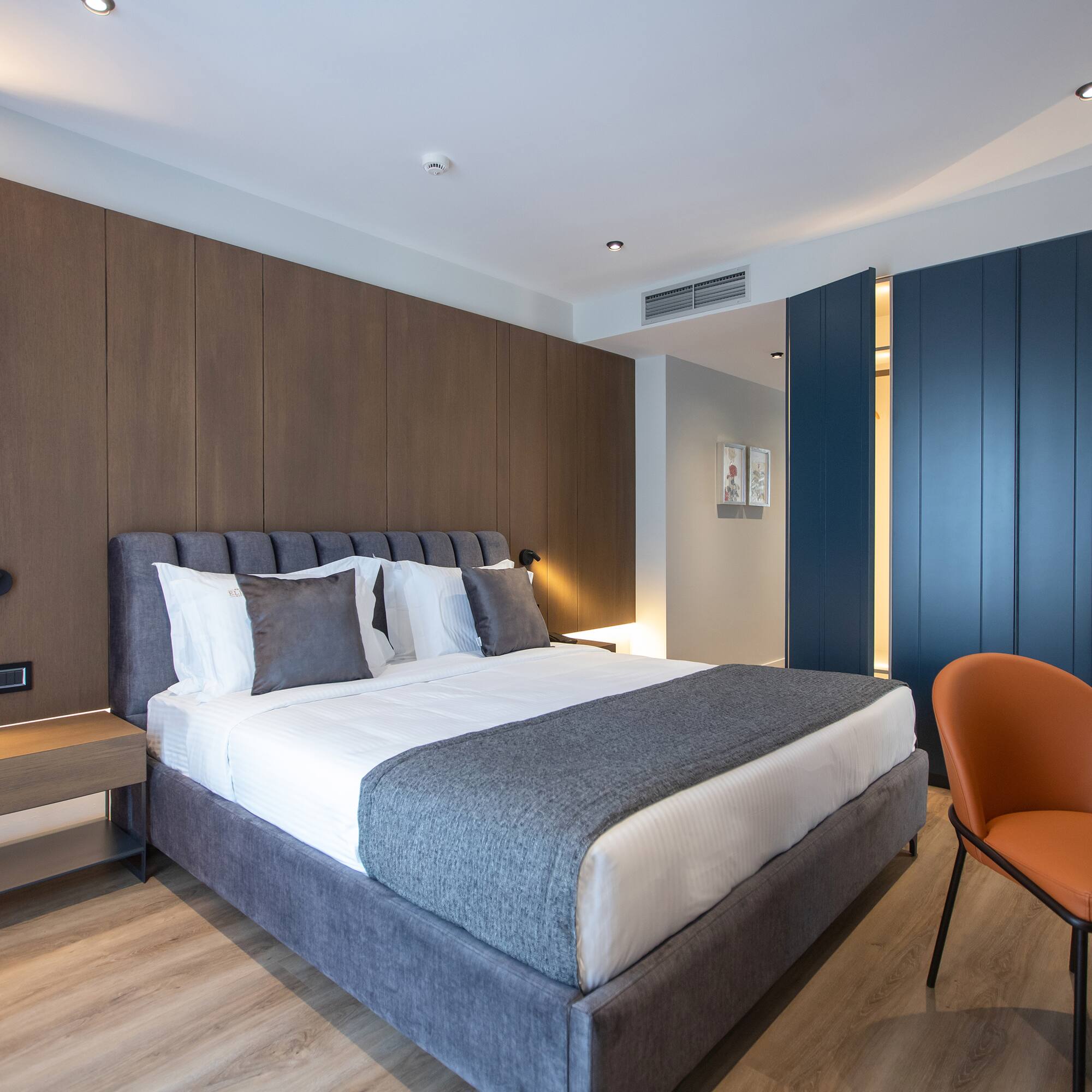 a bedroom with a bed and a chair