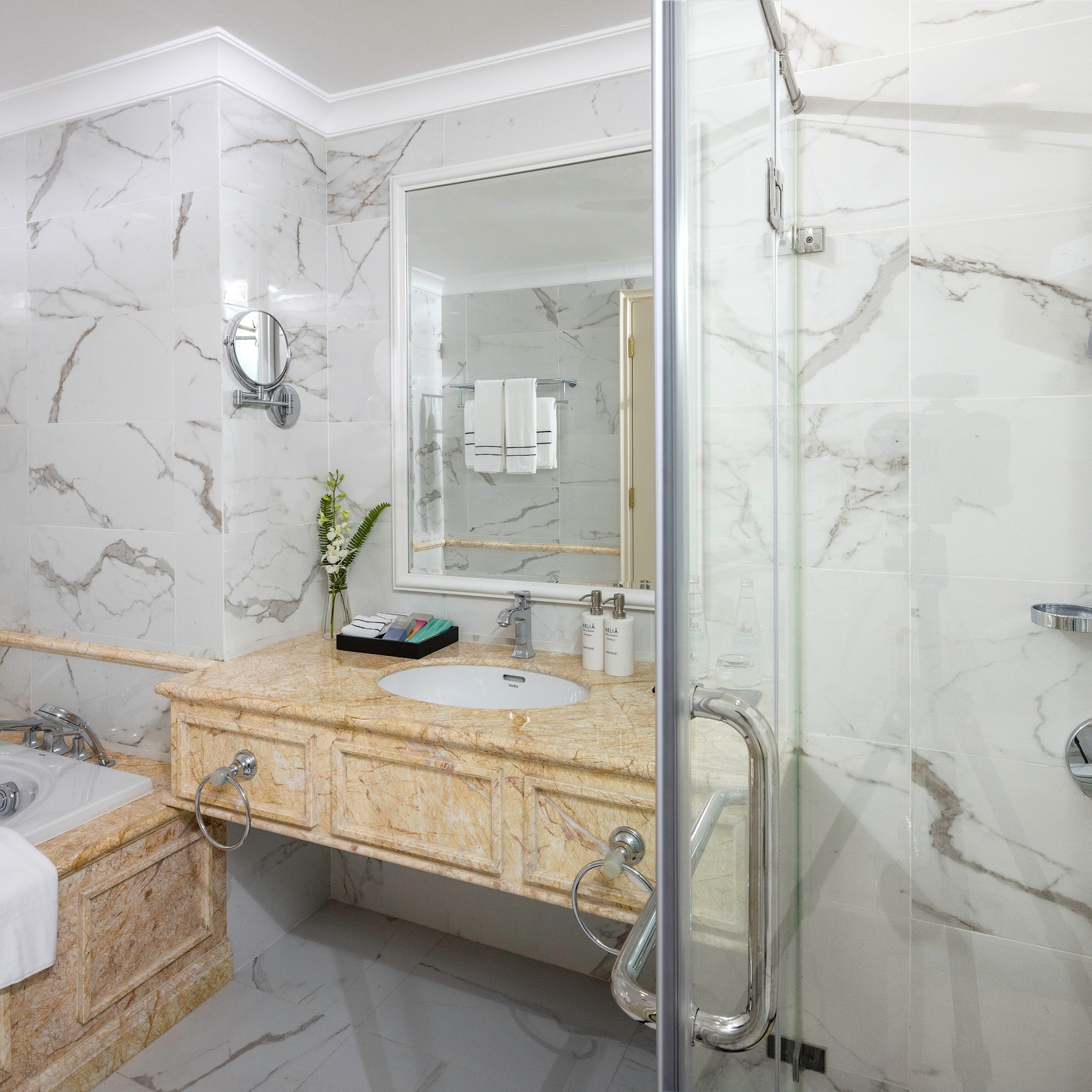 a bathroom with marble walls and a bathtub