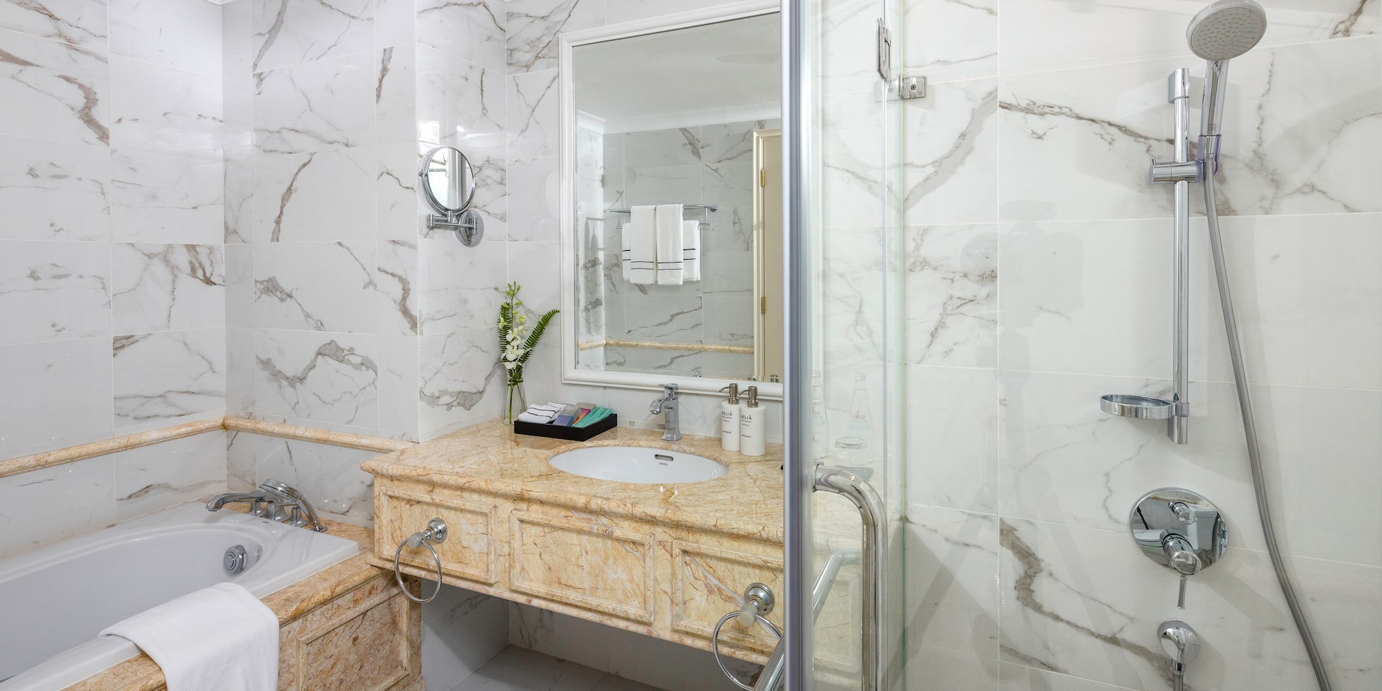 a bathroom with marble walls and a bathtub