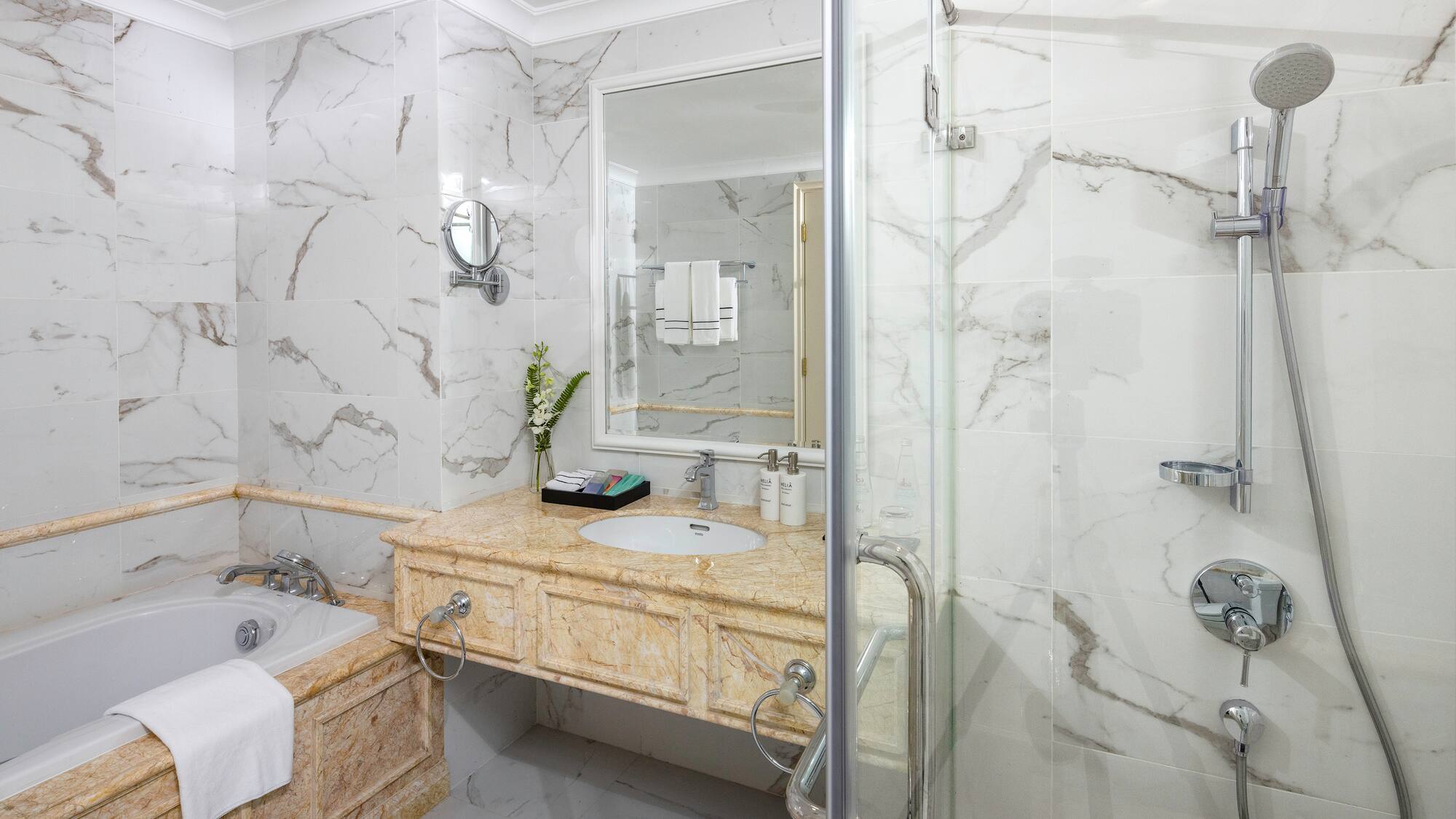 a bathroom with marble walls and a bathtub