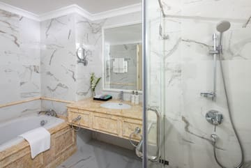 a bathroom with marble walls and a bathtub