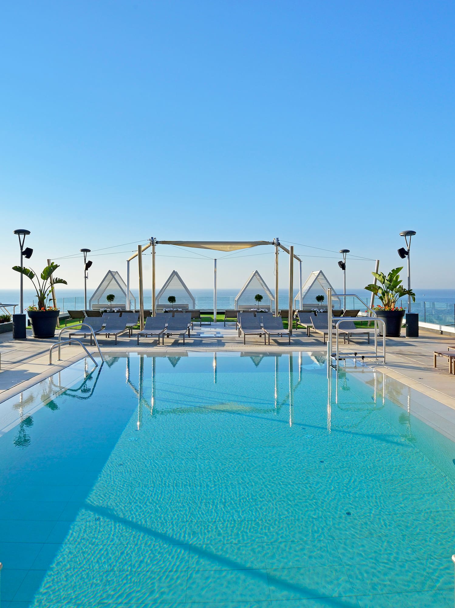 a swimming pool with a deck chair and a roof top